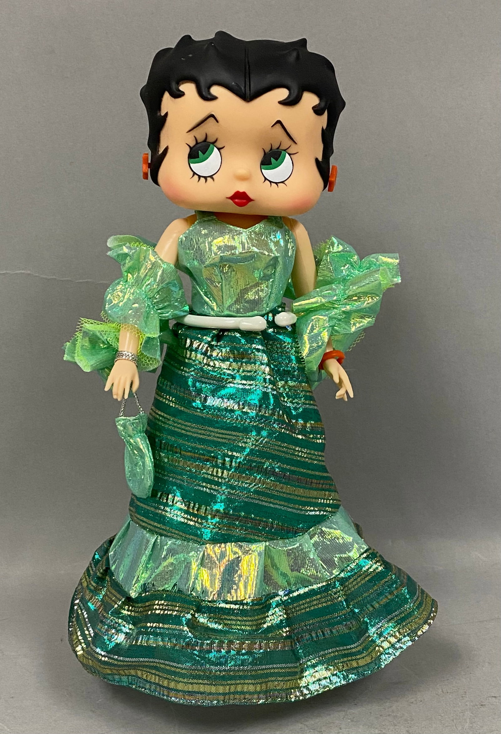 Marty Toy 1986 Betty Boop Fashion Doll: A 1986 Marty Toy vinyl fashion doll representing the character Betty Boop. The doll features a large stylized head with molded black hair and painted facial features, including signature large eyes