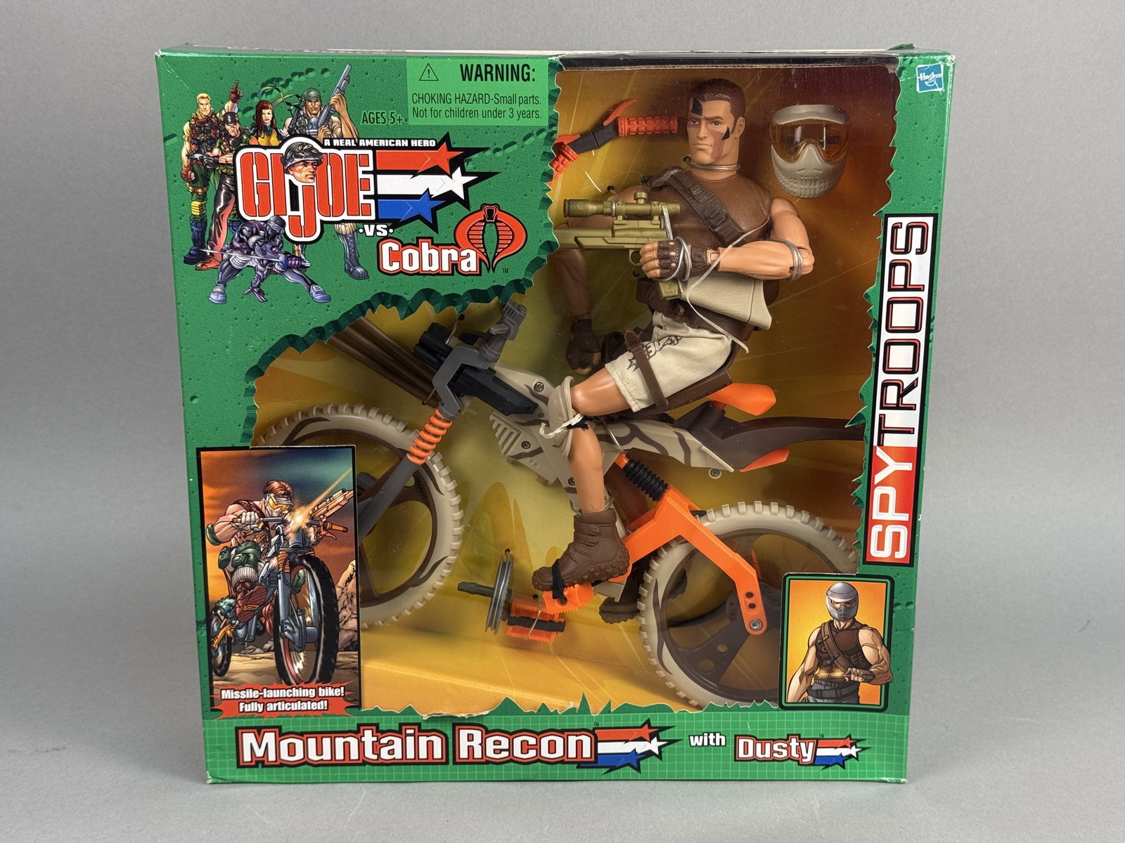 Hasbro G.I. Joe Mountain Recon Dusty: A factory-sealed Hasbro G.I. Joe vs. Cobra: Spy Troops action figure and vehicle set titled Mountain Recon with Dusty. The 12-inch scale Dusty figure features camouflage face paint and is outfitted in