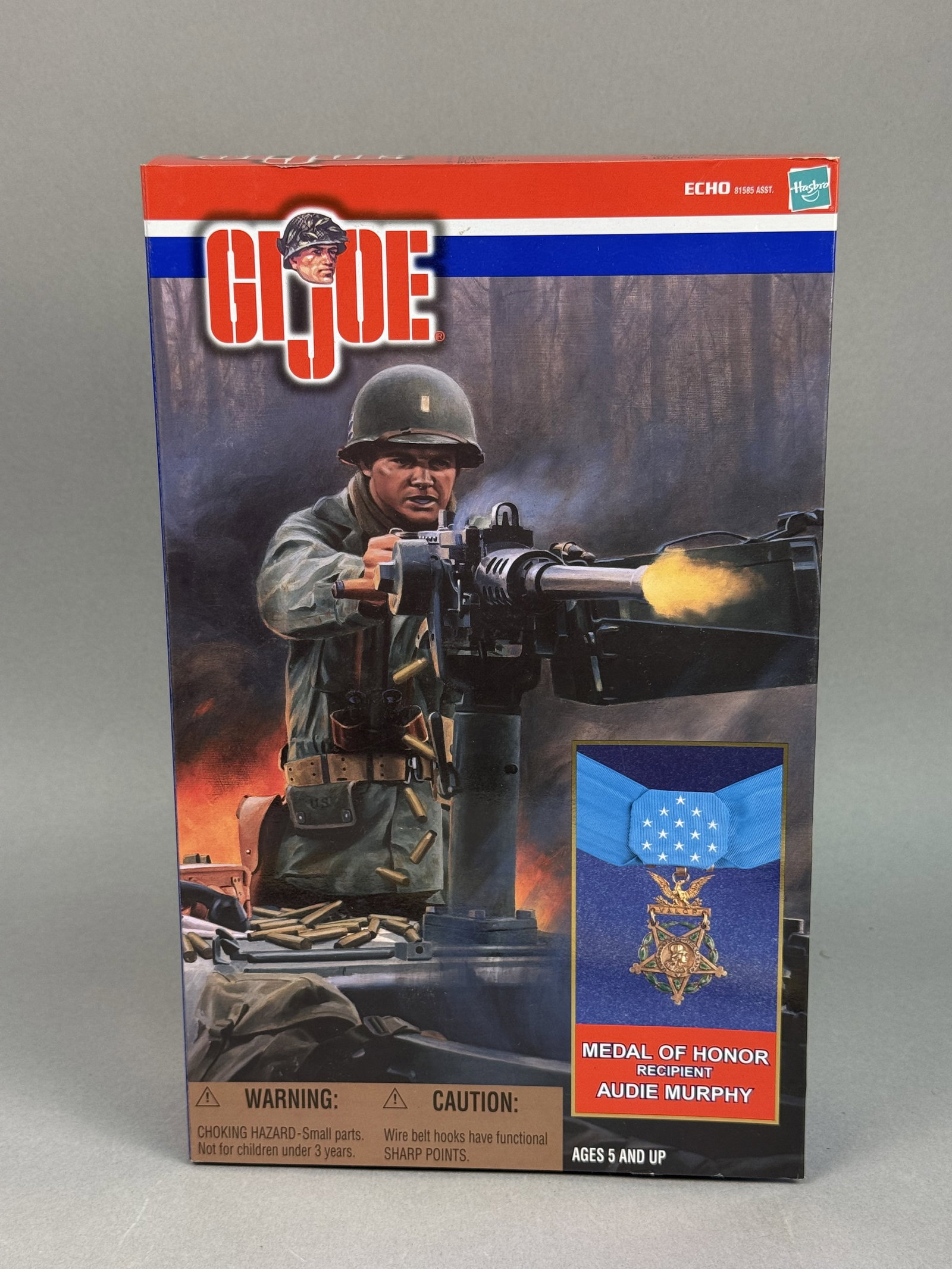 Hasbro G.I. Joe Audie Murphy Action Figure: A 12-inch scale plastic action figure commemorating Medal of Honor recipient Audie Murphy, manufactured by Hasbro as part of the G.I. Joe Classic Collection. T The piece is housed in its original wind