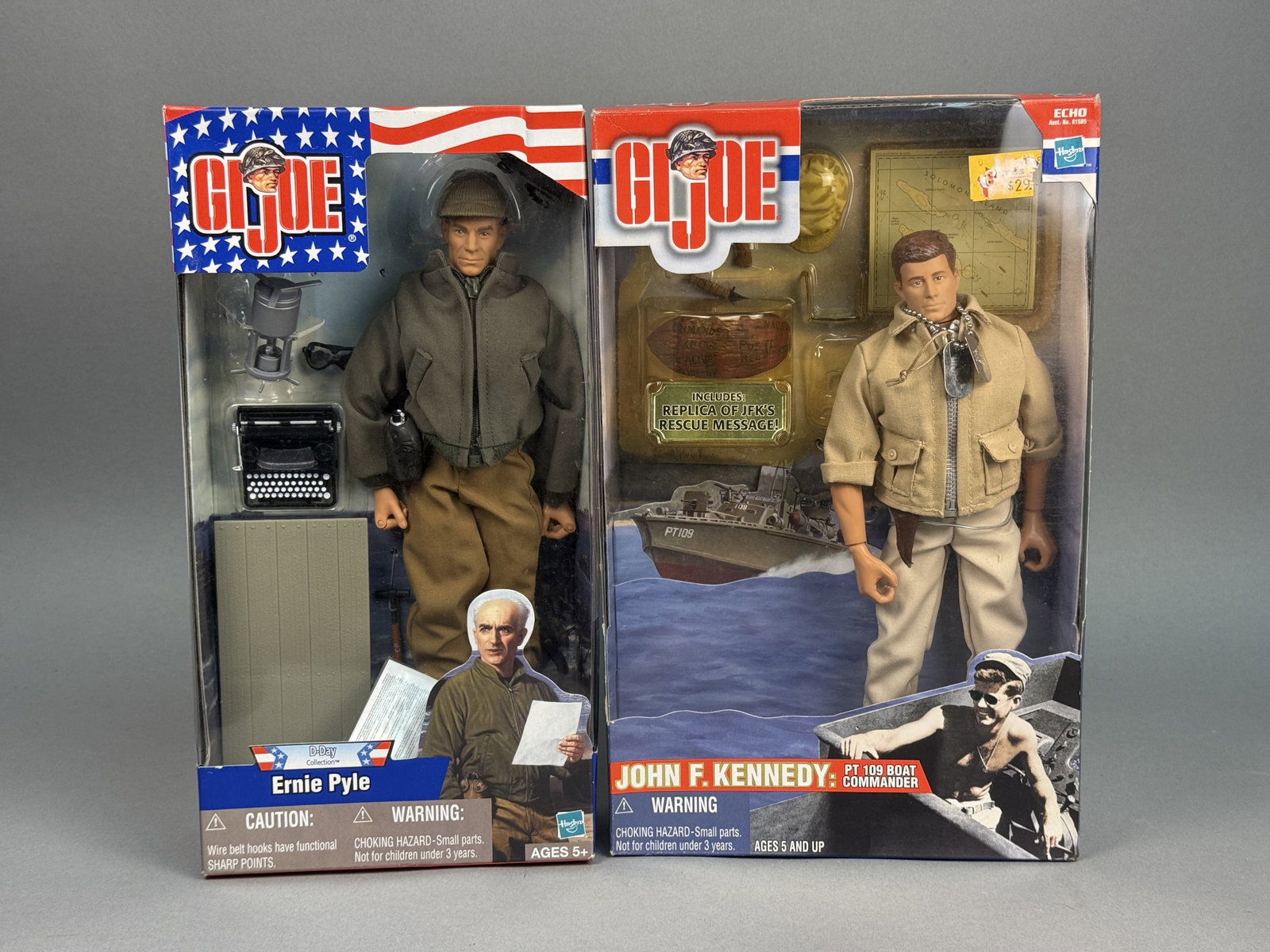 Hasbro G.I. Joe Pyle & JFK Action Figures: A pair of 12-inch scale articulated action figures manufactured by Hasbro, Inc. representing historical World War II figures. The lot features Ernie Pyle from the D-Day Collection and John F. Kennedy 