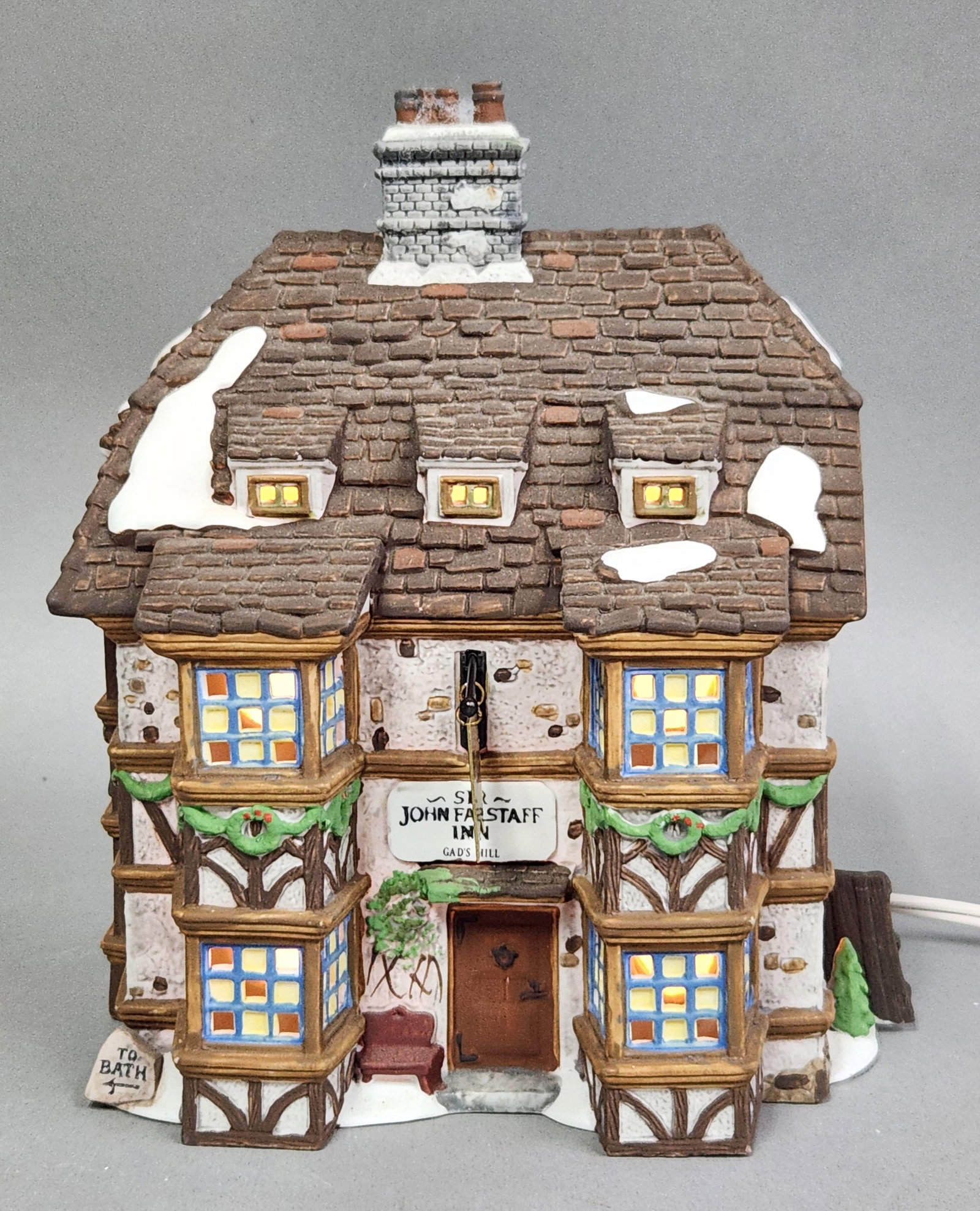 Department 56 Sir John Falstaff Inn: This Department 56 hand-painted porcelain building is titled Sir John Falstaff Inn and belongs to the Dickens' Village Series, part of the Heritage Village Collection. The underside bears printed
