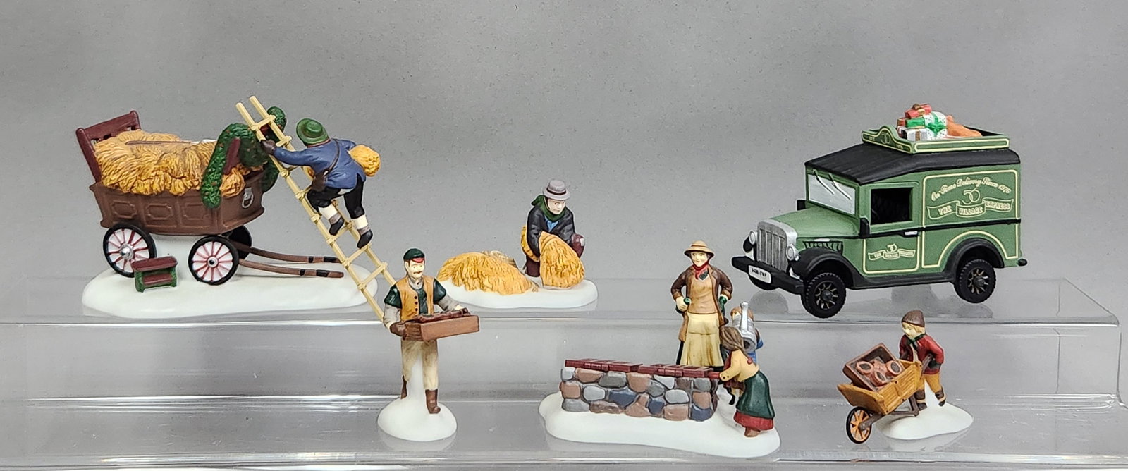 Dept 56 Porcelain Heritage Village Accessories: A group of seven hand-painted porcelain accessories from the Department 56 Heritage Village Collection, including three distinct boxed sets. The collection features a Village Express Van, model 5865-3