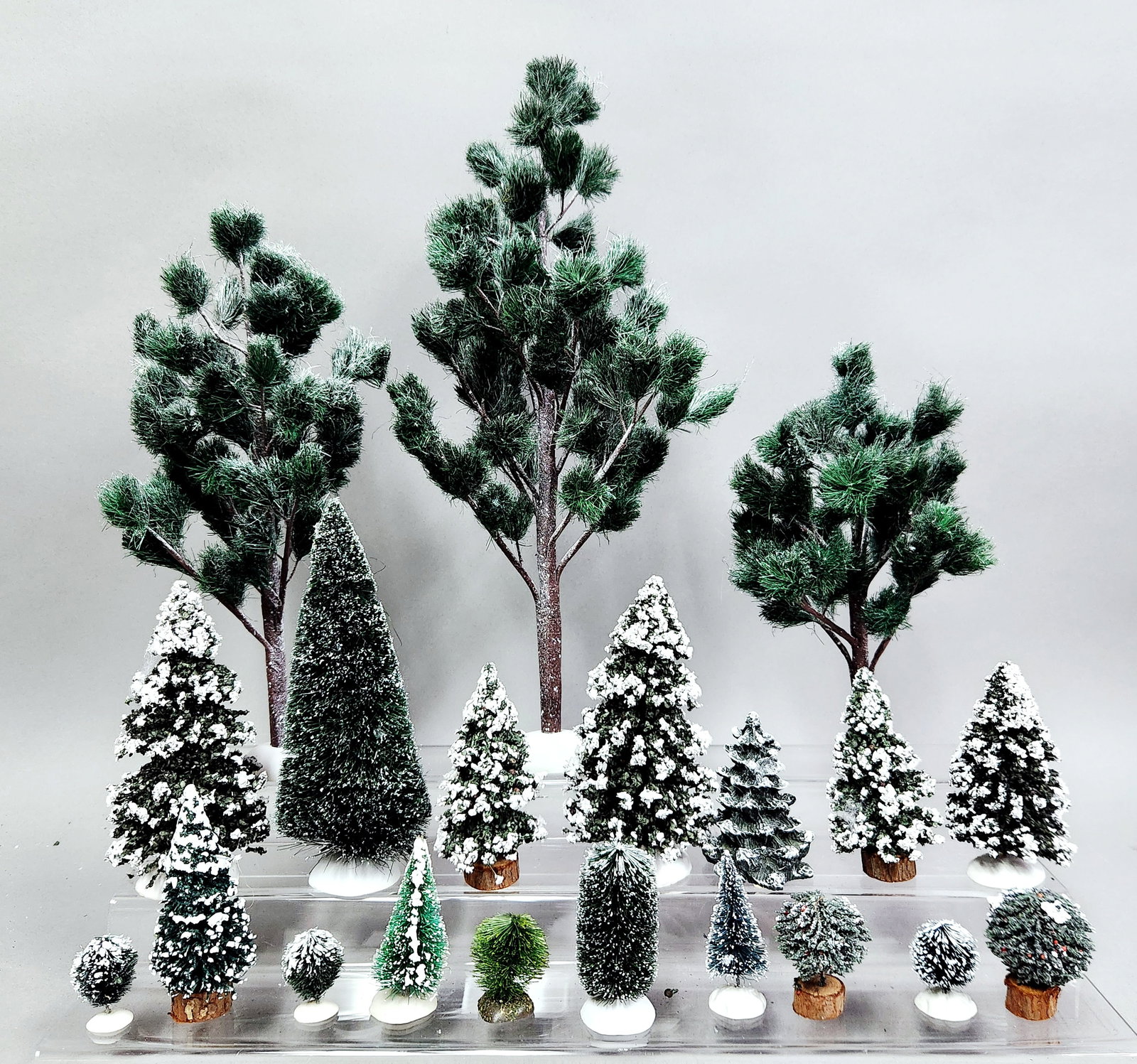 Dept 56 Snow-Covered Trees & Hedges: An assortment of miniature landscaping accessories from the Department 56 Village collection. The grouping features a set of three Jack Pines and a set of three Flexible Sisal Hedges, both provided wi