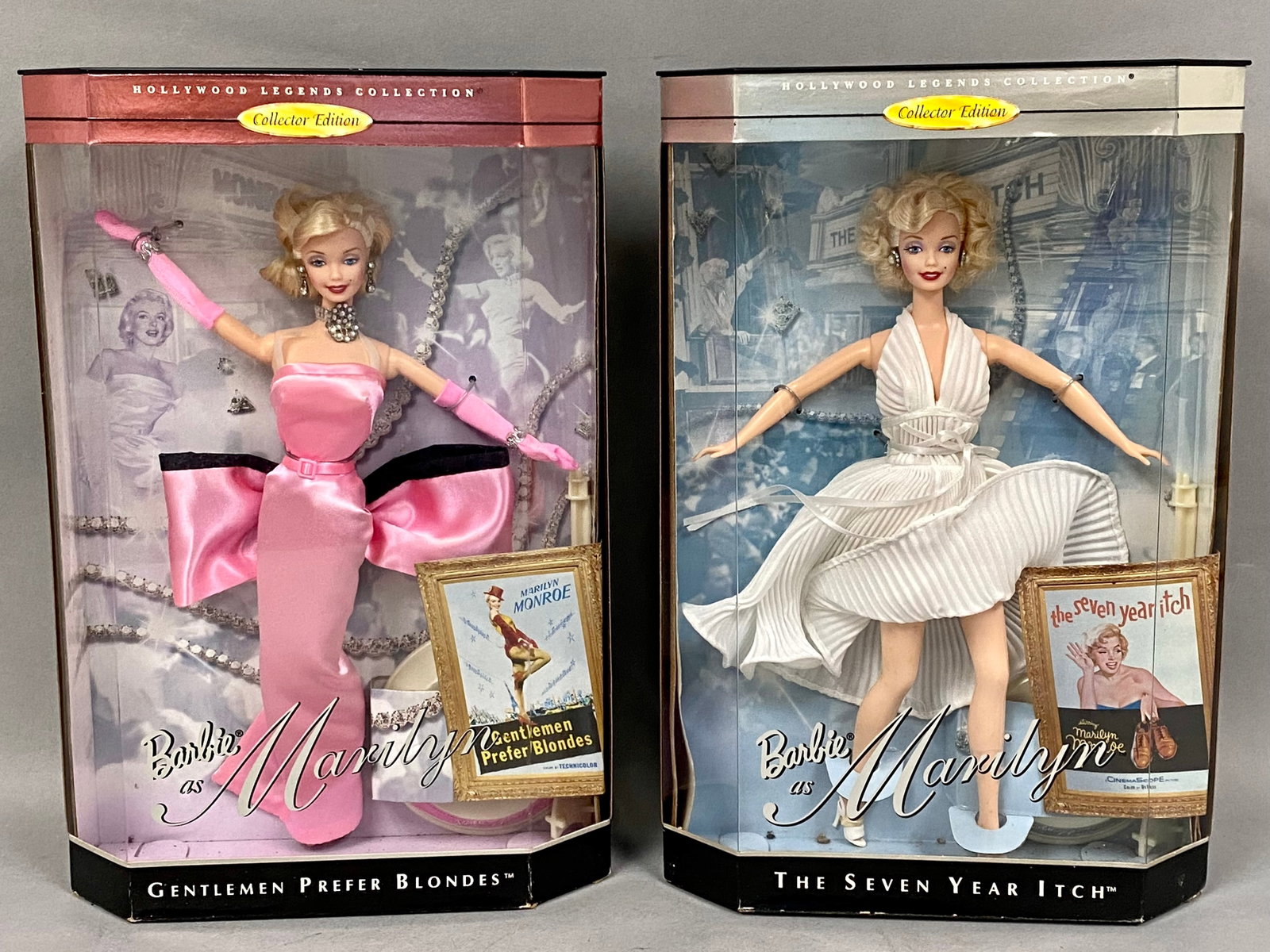 2 Mattel Hollywood Legends Marilyn Monroe Barbies: This set of two vinyl collector dolls from the Mattel Hollywood Legends Collection features Barbie as Marilyn Monroe. The first doll portrays the actress in Gentlemen Prefer Blondes wearing a pink sat