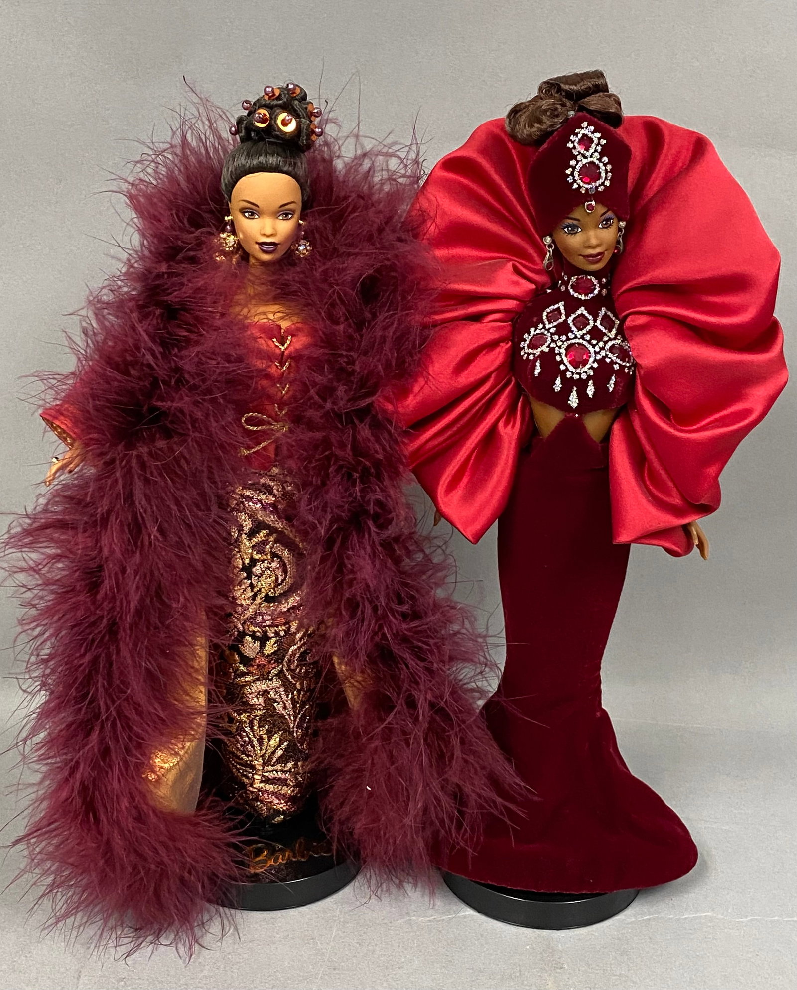 Mattel Vinyl Treasures of Africa Barbie Dolls: A pair of vinyl fashion dolls from the Mattel Treasures of Africa collection, designed by Byron Lars. The Moja figure features a dark skin tone with rooted dark hair styled in a high topknot accented 