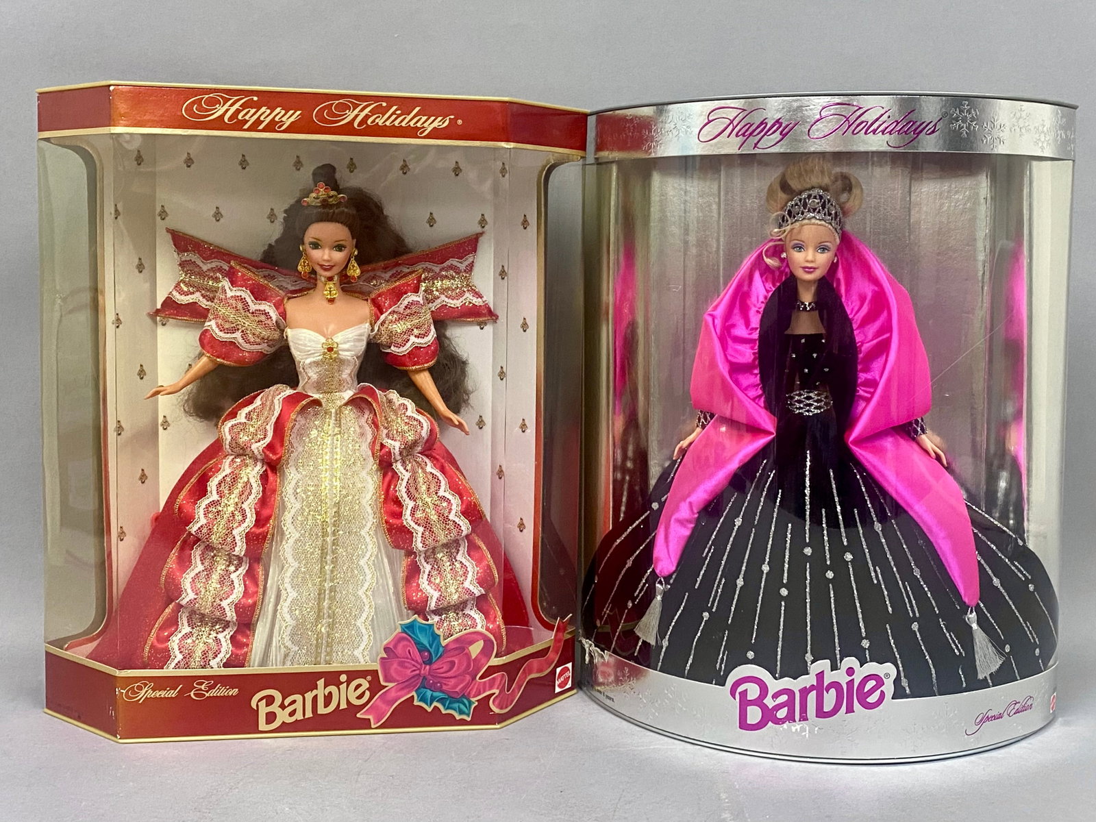 Mattel Happy Holidays Special Edition Barbie Dolls: This lot features two Mattel Special Edition Barbie dolls from the Happy Holidays collection, including the 1997 and 1998 releases. The 1997 doll is designed with dark brown hair styled in a formal up