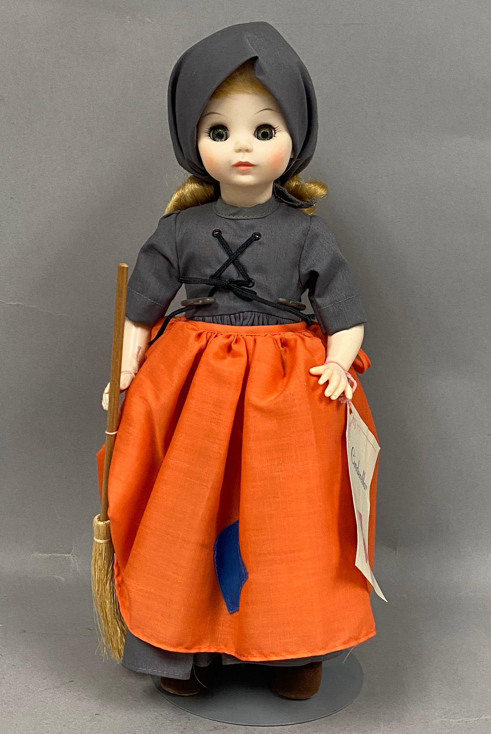 Madame Alexander Poor Cinderella Storybook Doll: This Madame Alexander storybook character doll depicts the figure Poor Cinderella in her domestic attire. The doll is constructed of jointed hard plastic and features a blonde wig styled in ringlets p