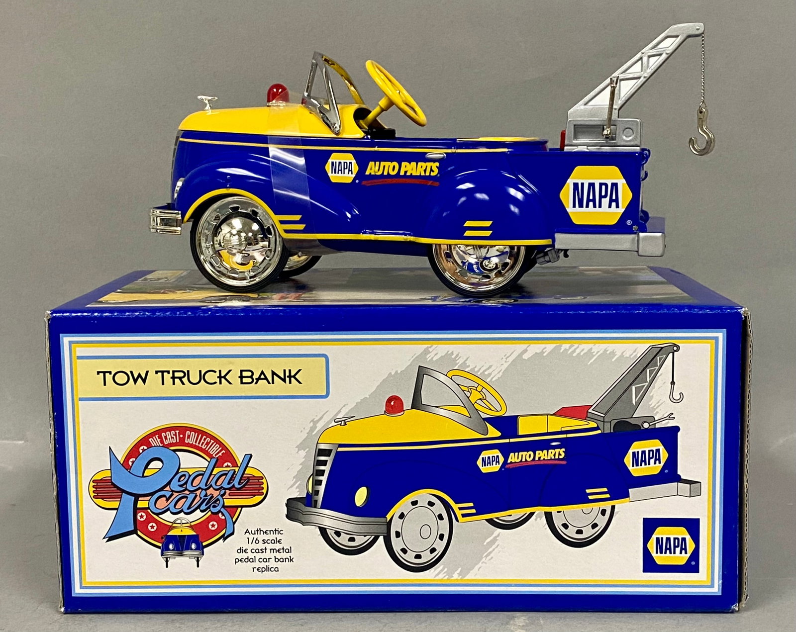 Crown Premiums NAPA Gendron Tow Truck Bank: A 1:6 scale die-cast metal replica of a 1940 Gendron tow truck bank, manufactured in 1999 by Crown Premiums for NAPA Auto Parts. The vehicle body is finished in blue and yellow with NAPA AUTO PARTS de