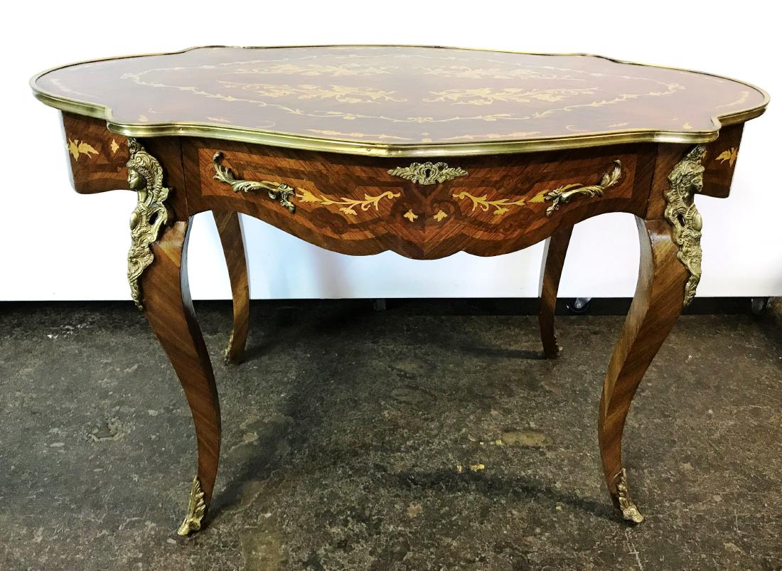 ?Highly Ornate Contemporary Inlaid Table w/ Gold Ormolu: This Highly Decorative Contemporary center table in burled wood veneer with gold border and marquetry inlaid flowers and vines. This table is decorated in br?onze? trim with ?a ?large lockable drawer 