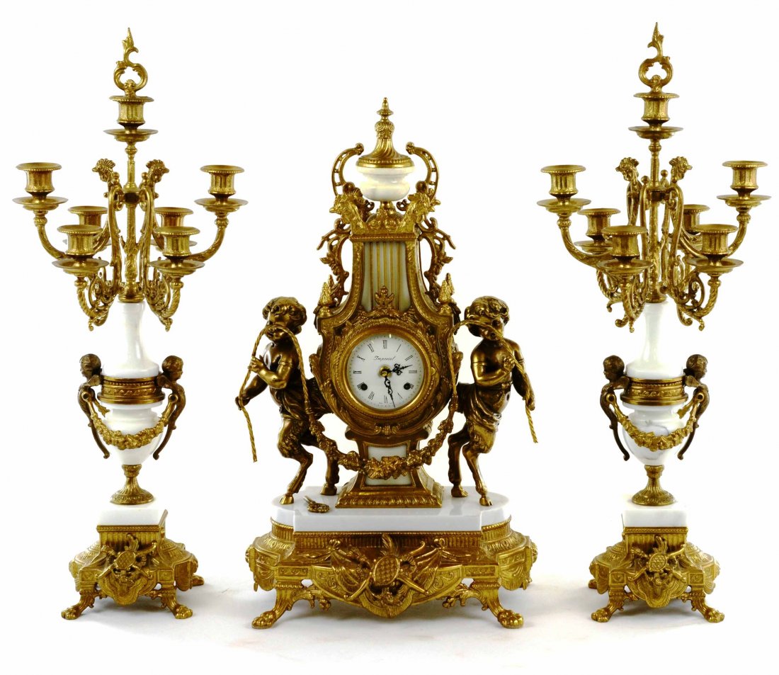 Italian Imperial Brass Mantle Clock w/ Candleabras: This Vintage Italian Imperial Brass Mantle Clock with Matching Candelabras is in wonderful condition. The clock does have a key, however we have not attempted to wind it. The face has some minor key w