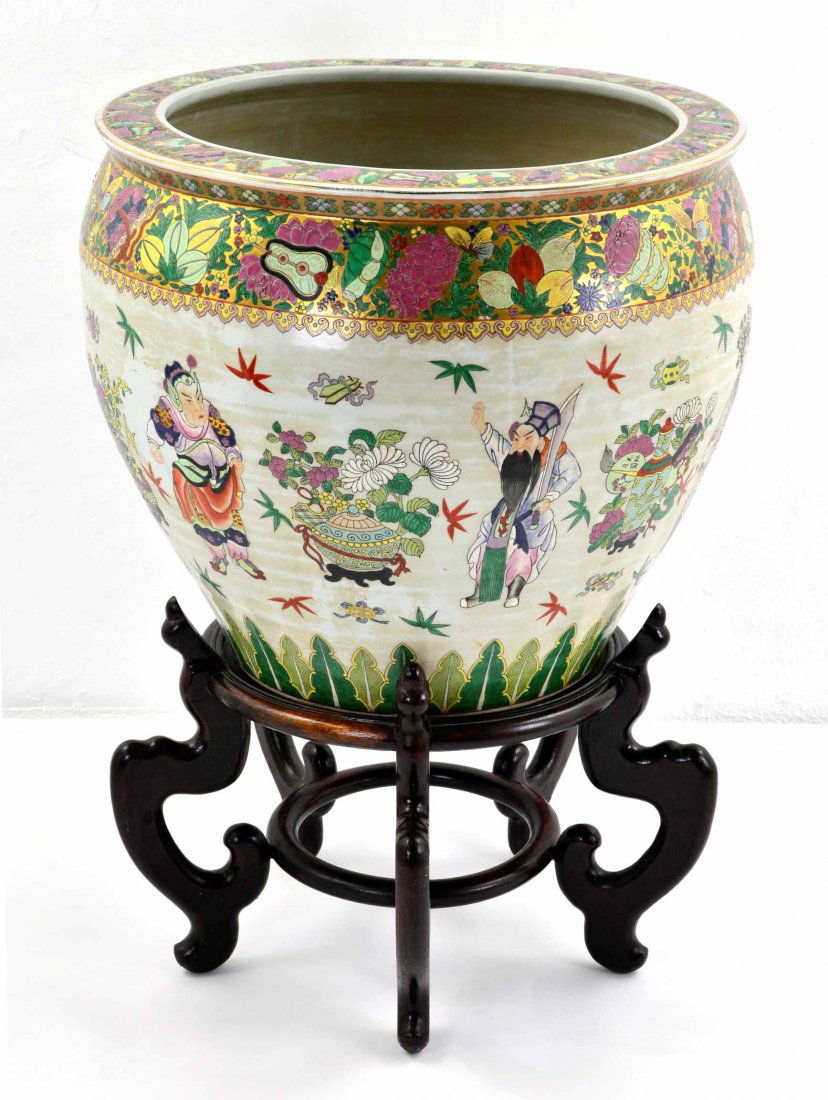 Large Decorative Oriental Planter w/ Wooden Stand: This is a Very Large Oriental Decorative Planter with a Wooden Stand. This beautiful vase has designs of Asian dressed men in robes holding swords, bamboo and fruit. There are colors of pinks, greens