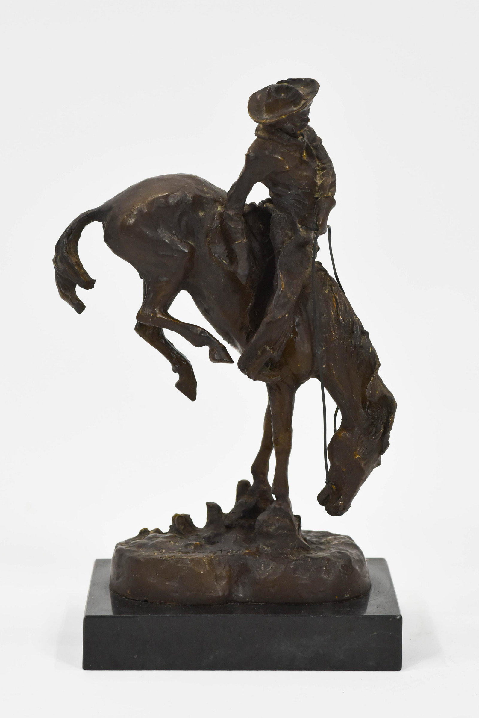 Frederic Remington Bronze Cast Sculpture “The: Lost Wax Casting captures the explosive moment when the “great spirit” of the horse collides with the tenacity of the cowboy.