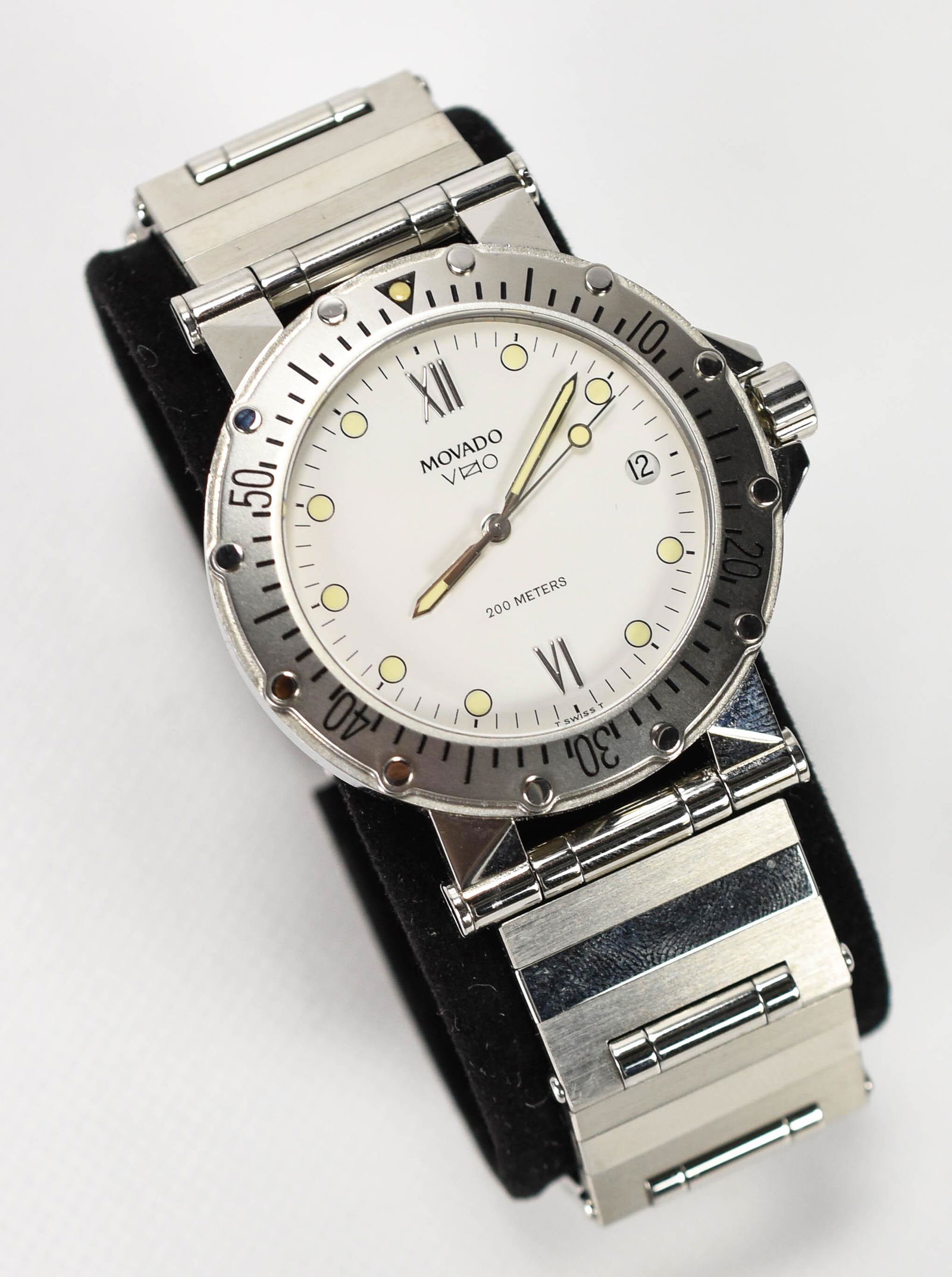 Movado Vizio Stainless Steel Quartz Watch 84.C2.888: New old stock. Never worn, new in box with booklets. Rotating bezel. Has the letters "MCS" lightly etched on the back case above the word Movado. Otherwise, the 37mm stainless steel case and band exce