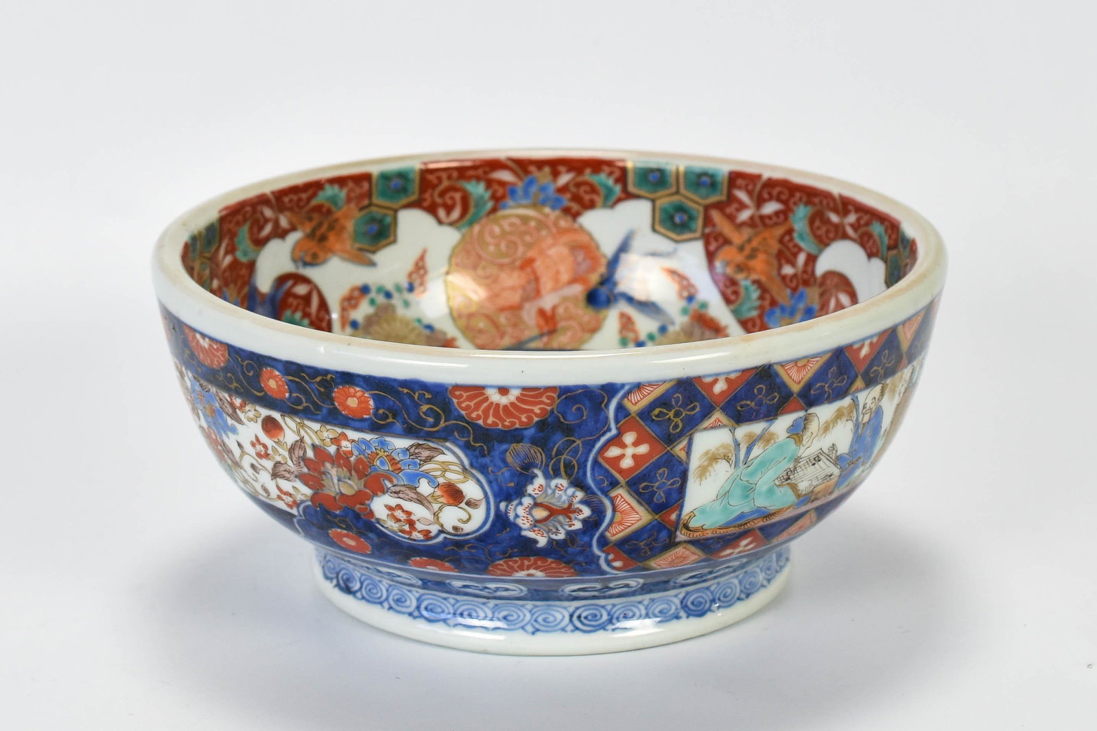 Fine Antique Japanese Imari Porcelain Footed Bowl: Circa 1825-1875. No chips, cracks or repairs. The well done and finely intricate enamel decoration includes panels of men playing Go, having tea and reciting from a text. Fish, flowers, birds and inse