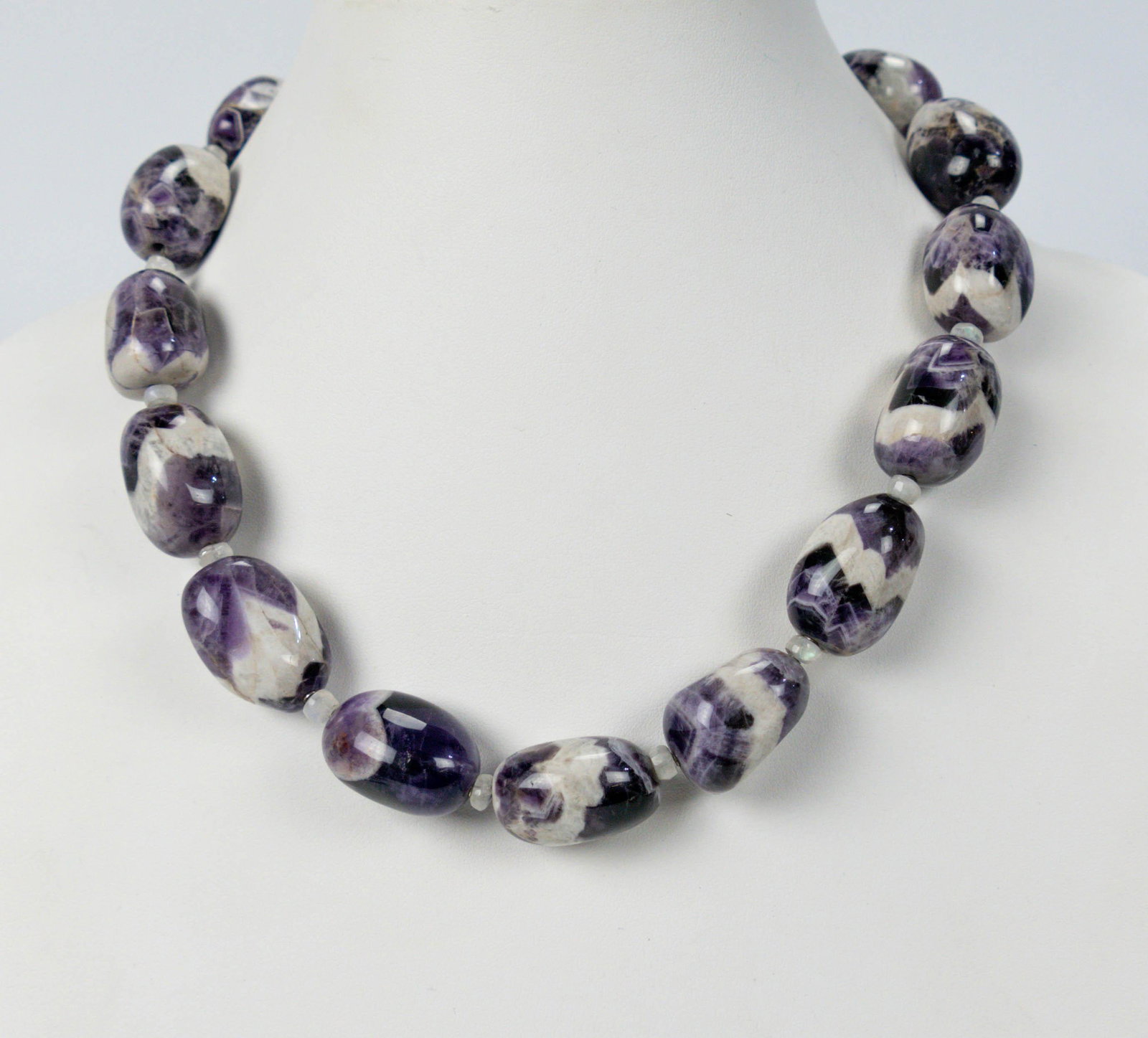 Korean Chosun Hotel Variegated Amethyst Bead Necklace: Circa 1954-1964. Excellent original condition, each bead features a scarce variegated bright white and purple amethyst color. The bead size average is approx. 27mm length. This 16" choker necklace was
