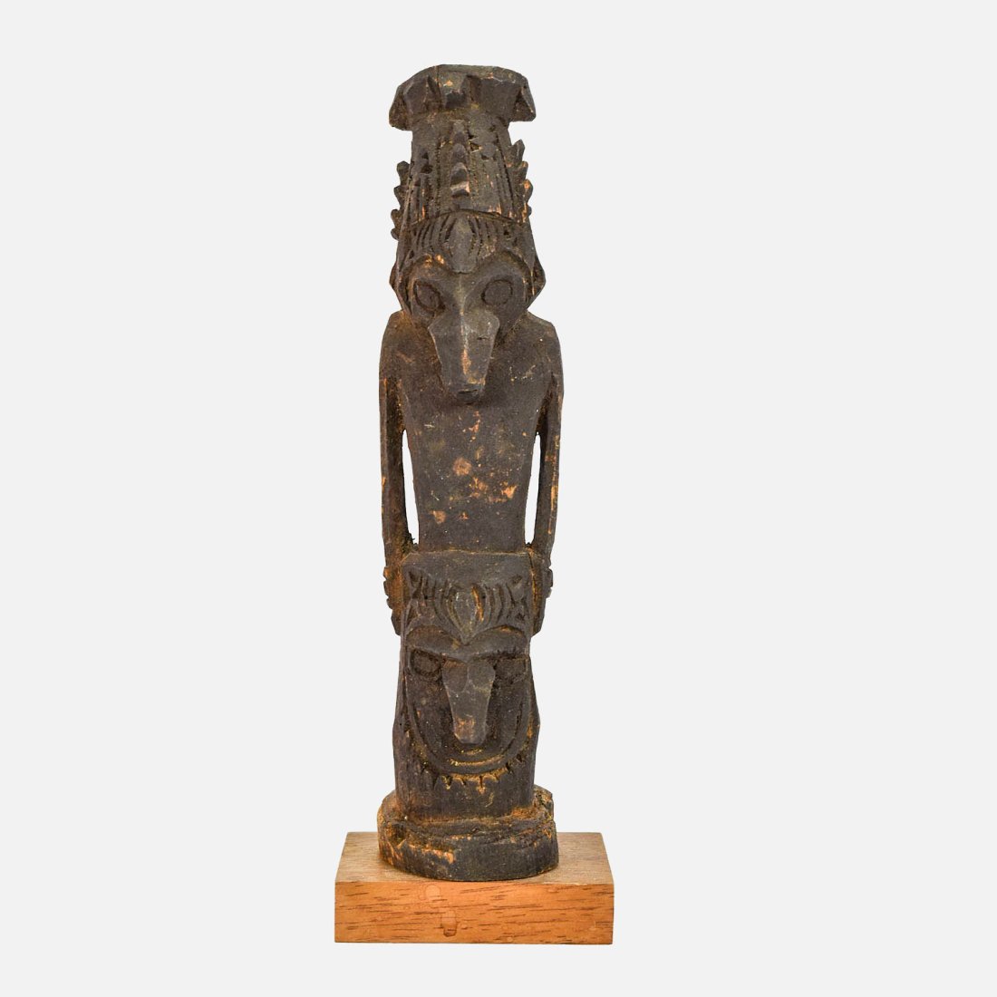 Pacific Islands Oceania Carved Wood Totem Figure: Ca. Late 19th to Early 20thC. Wear and partial wood loss on base of figurine. The block of wood used as a plinth is a later addition.