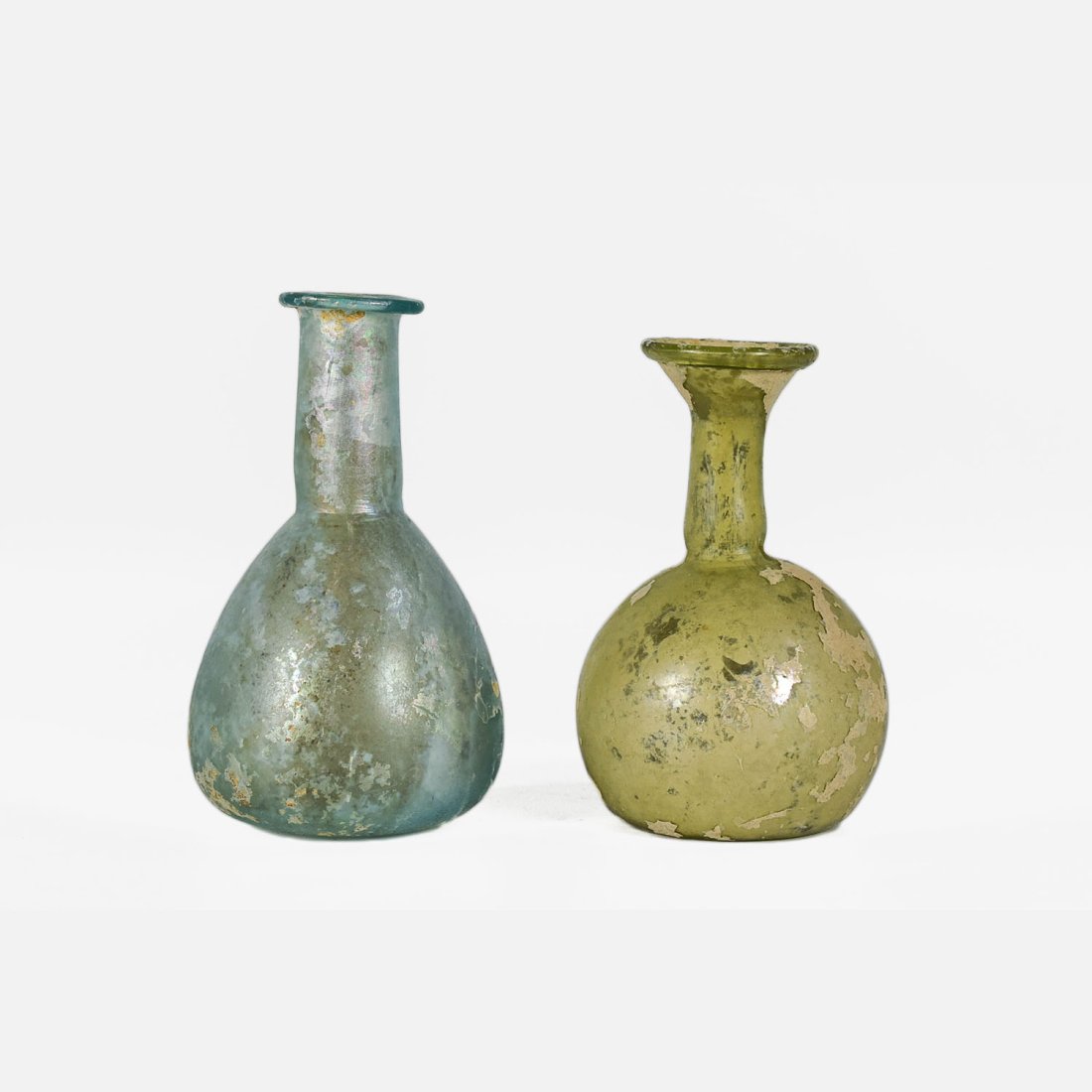 Ancient Roman Glass Bottle Pair: Ca. 1st-2nd Century AD. Both bottles fine with No chips, cracks or repairs. Ex-Samuel Lewis estate.