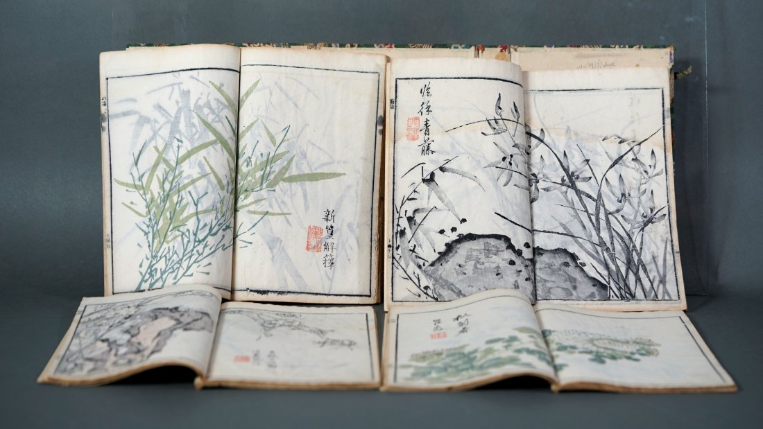 Antique Japanese Woodcut Print Book 4 Volumes Poems: 4 Volume set of woodcuts and poems. Set is enclosed in green fabric with a crane motif. No date. 10" x 6.4" x 1.5". Pages are still supple and flexible. Some pages have pink staining. In the top volum