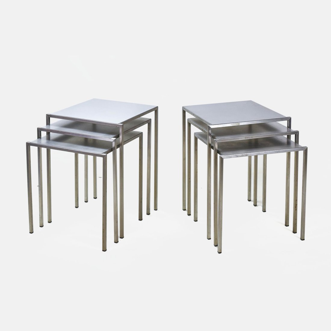Two Sets of Modern Silver Nesting Tables: Overall good condition, some minor smudge marks as show and minor surface scratches on few small areas of some legs.