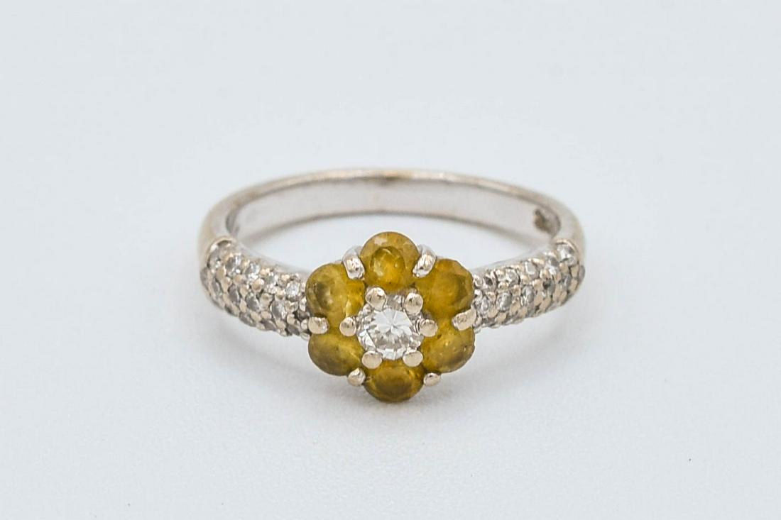 Fine Doves 18K Yellow Gold Diamond & Yellow Topaz Ladies Ring: Ca. last half 20thC. Very good condition with thirty-two 1mm diamonds flanking six 3mm yellow topaz gemstones surrounding one 3 1/2 mm center diamond. Marked "Doves" and "18K". Approx. weight 4.2 gram