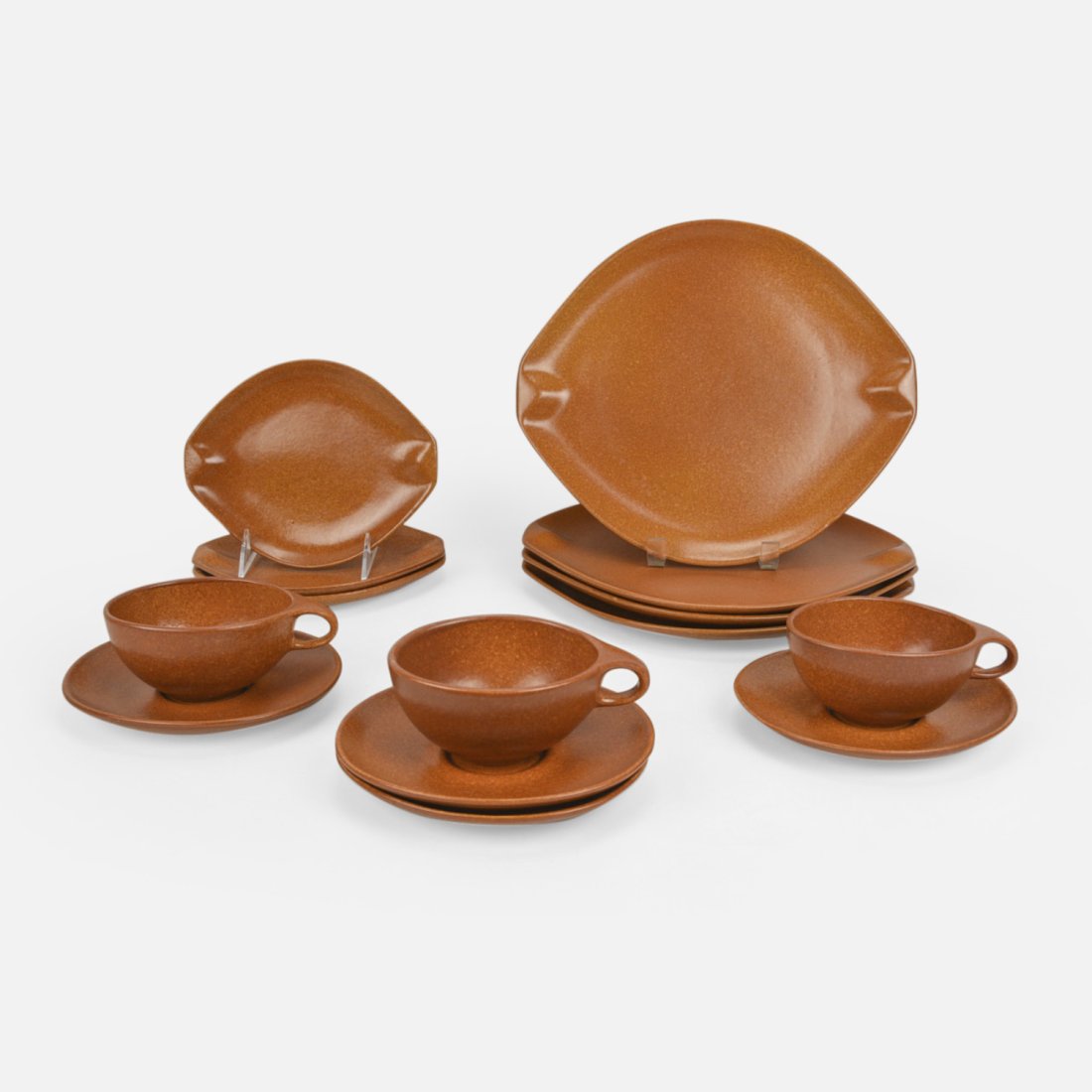 Ben Seibel for Roseville Raymor Set of Pumpkin Orange Tea Cups, Plates, and Saucers MCM: Ca. second half 20thC. Designed by Ben Seibel for Roseville Raymor. Includes three cups, four saucers, three small plates, and four large plates. Small plates 6 1/2" x 7 3/4" Saucers 5 3/4" x 6 1/2" T