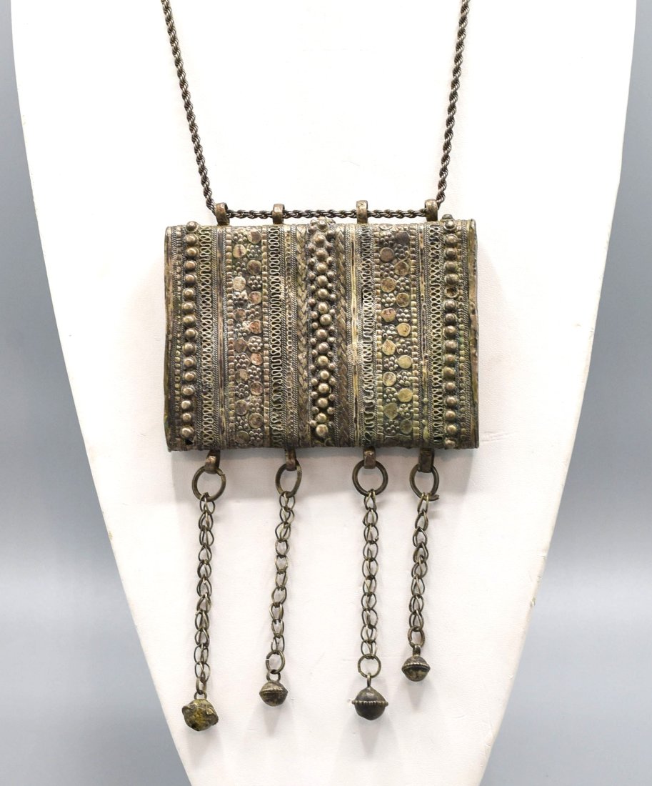 Rashaida Harar Pendant Necklace Ethiopia: This antique silver alloy pendant is a sealed Quran box in fairly good aged condition, showing surface wear and age appropriate dings. The soldered ends may be later replacements. Approx. 4 1/2" wide 
