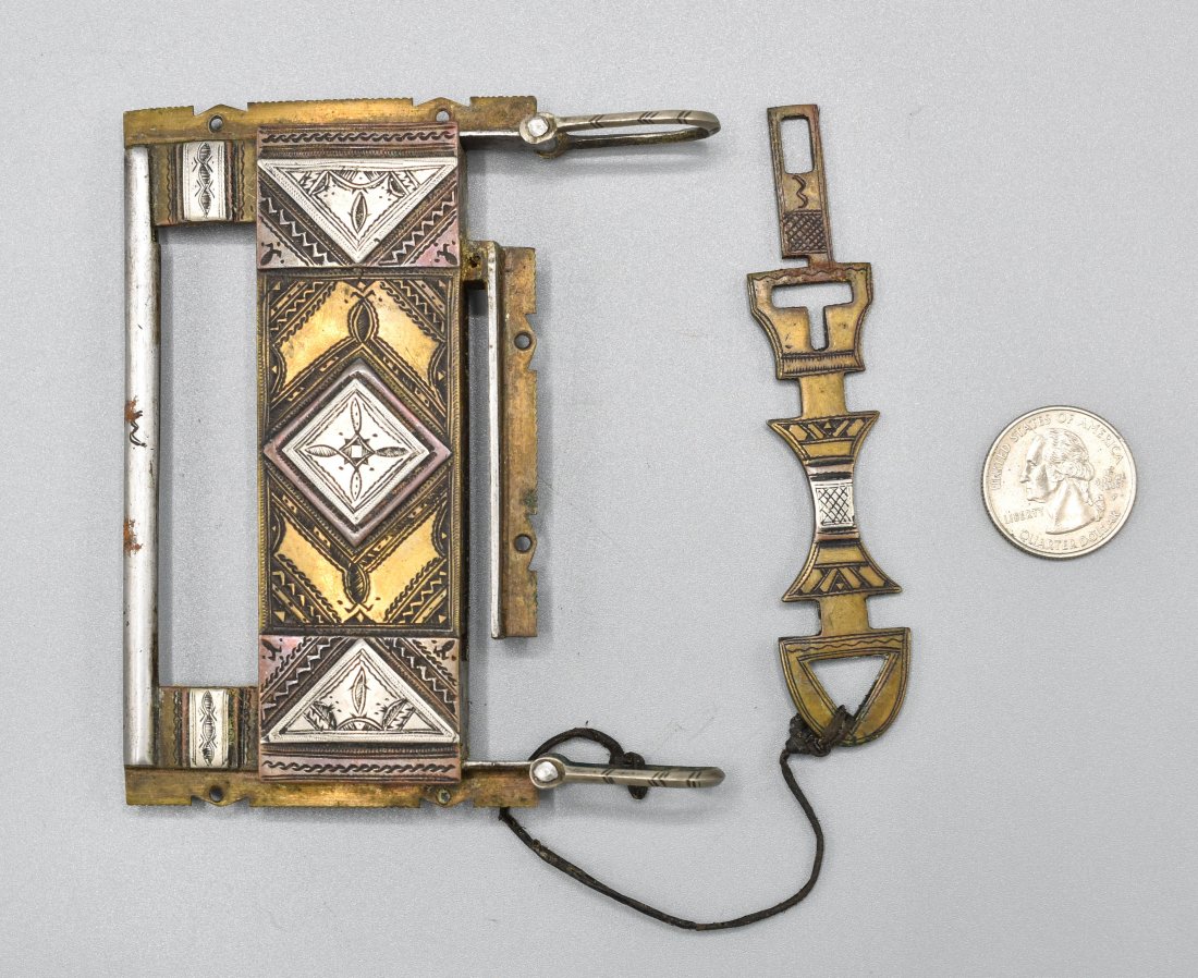 Tuareg Tamask Nâ€™Asrou Lock and Key Pendant: 20thC. Silver, brass and copper. Excellent original condition, complete as shown. Very intricate incised decorations are seen throughout on both sides, including the original key. Approx. 4 1/4" x 3 5