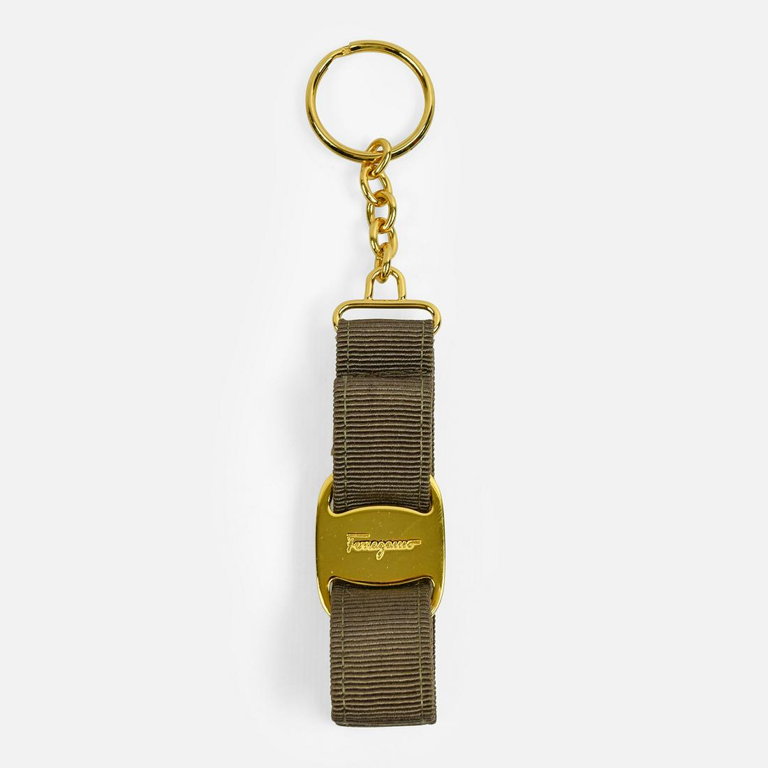 SALVATORE FERRAGAMO Ribbon Keychain: Made in Italy. Taupe canvas ribbon. Gold hardware. Keyring. Original box included
