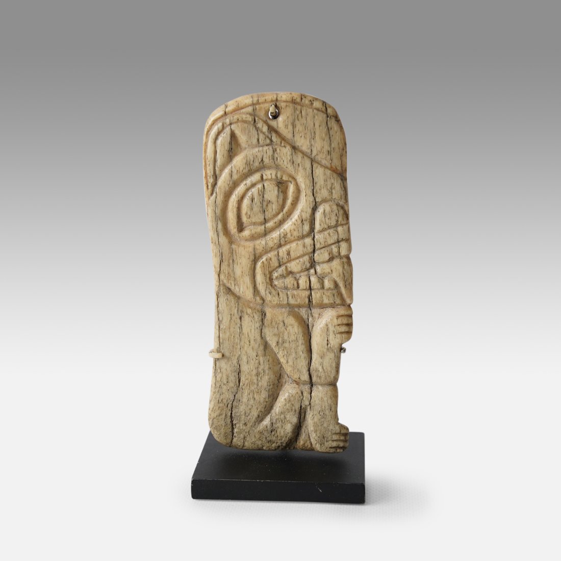 Antique 19thC Tlingit Northwest Coast Flat Carved Bone Otter Amulet Pendant: Ca. early to mid 19thC. Very good with no major breaks or repairs. Mounted on stand as shown. Ex-Nooter coll.