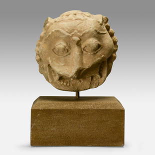 Antique 11thC Cambodian Carved Stone Lion Head Fragment: Very good with age appropriate surface issues; was once part of a larger piece. The carved stone head measures approx. 5 1/2" wide by 5 1/2" tall by 3 3/4" deep, without the stand. The custom stone ba