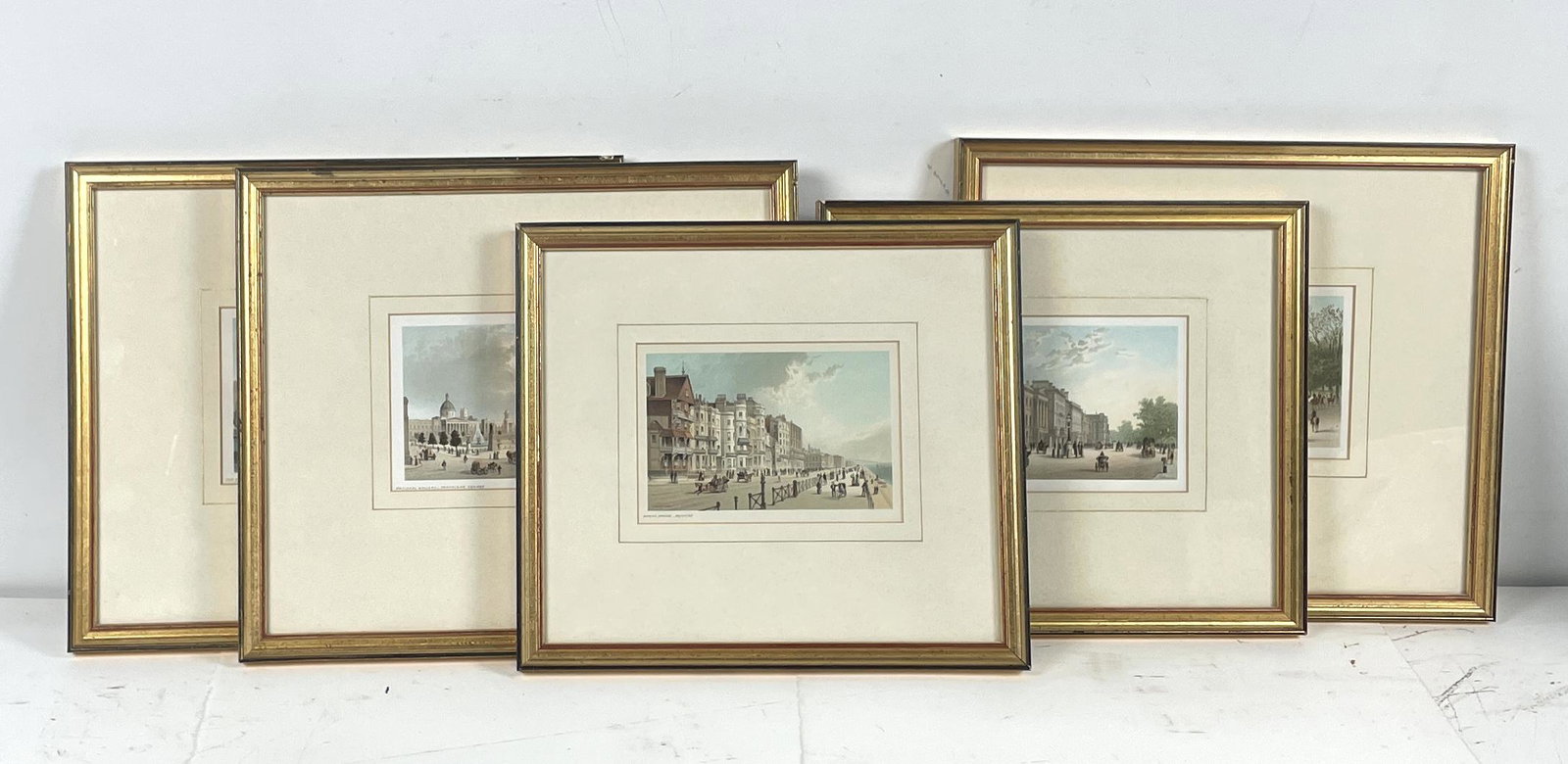 Set of Five T Nelson & Sons Antique Chromo Lithographs: Depicts "The Tower from the River", "The Row - Hyde Park", "National Gallery - Trafalgar Square", "Hyde Park Corner - Piccadilly", and "Marine Parade - Brighton". Framed and Matted. Vary in size but a