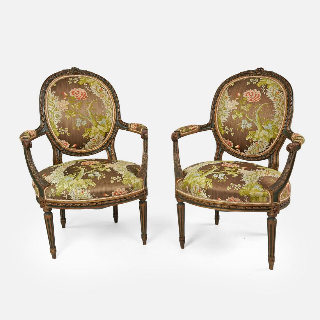 Pair French Louis XVI Style Armchairs: Ca. third quarter 19thC. Beautiful pair of carved oval back armchairs with floral upholstery in the style of Louis XVI, French. Seat measurements are as follows H: 17" W: 19" D: 20"