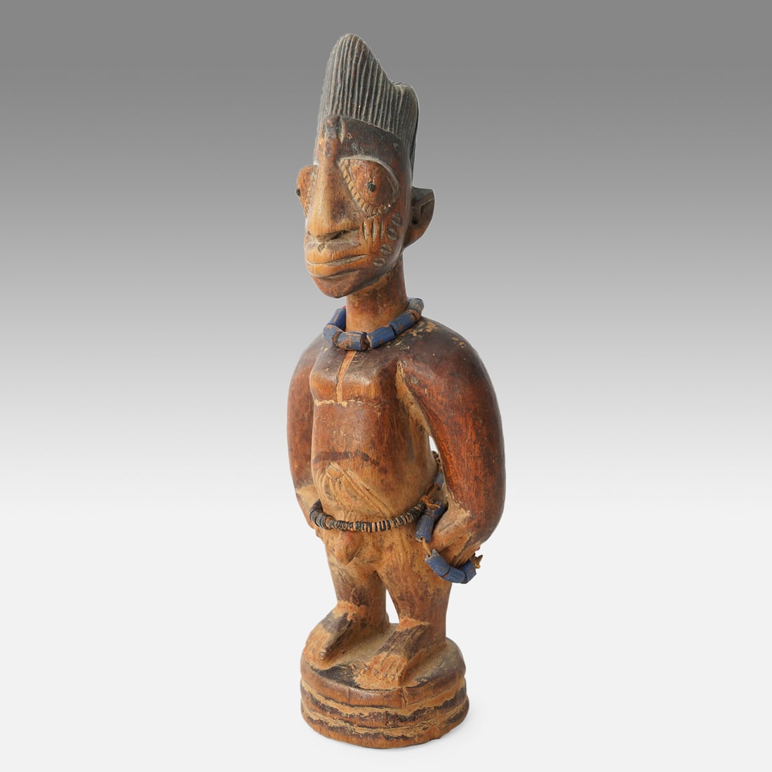 Yoruba Ibeji Twin Figure Oyo Style African Tribal Carved Wood w/Beads and Pigment Nigeria: Ca. early 20thC, possibly earlier. Very good with possible repair on neck, having original patina from repeated handling (The mother provides ritual care to the figures, bathing, dressing, adorning, a
