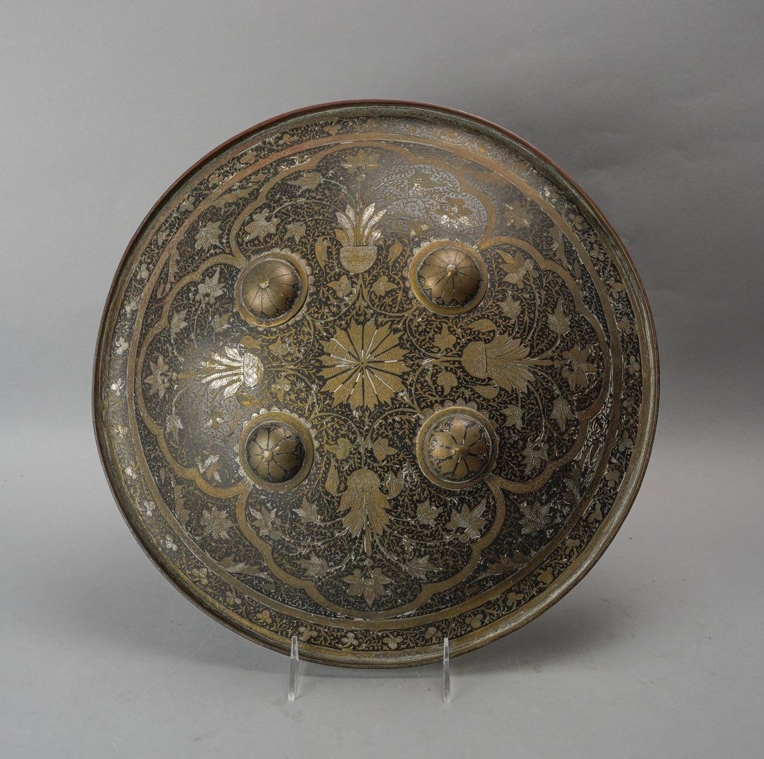 Antique 19thC Silvered Brass and Steel Shield- A Fine Mughal Dhal from India: Ca. 2nd to 3rd quarter 19thC. Very good original condition with no apparent repairs of major condition issues. The four prominent metal bosses are applied at the points to which the handles are fasten