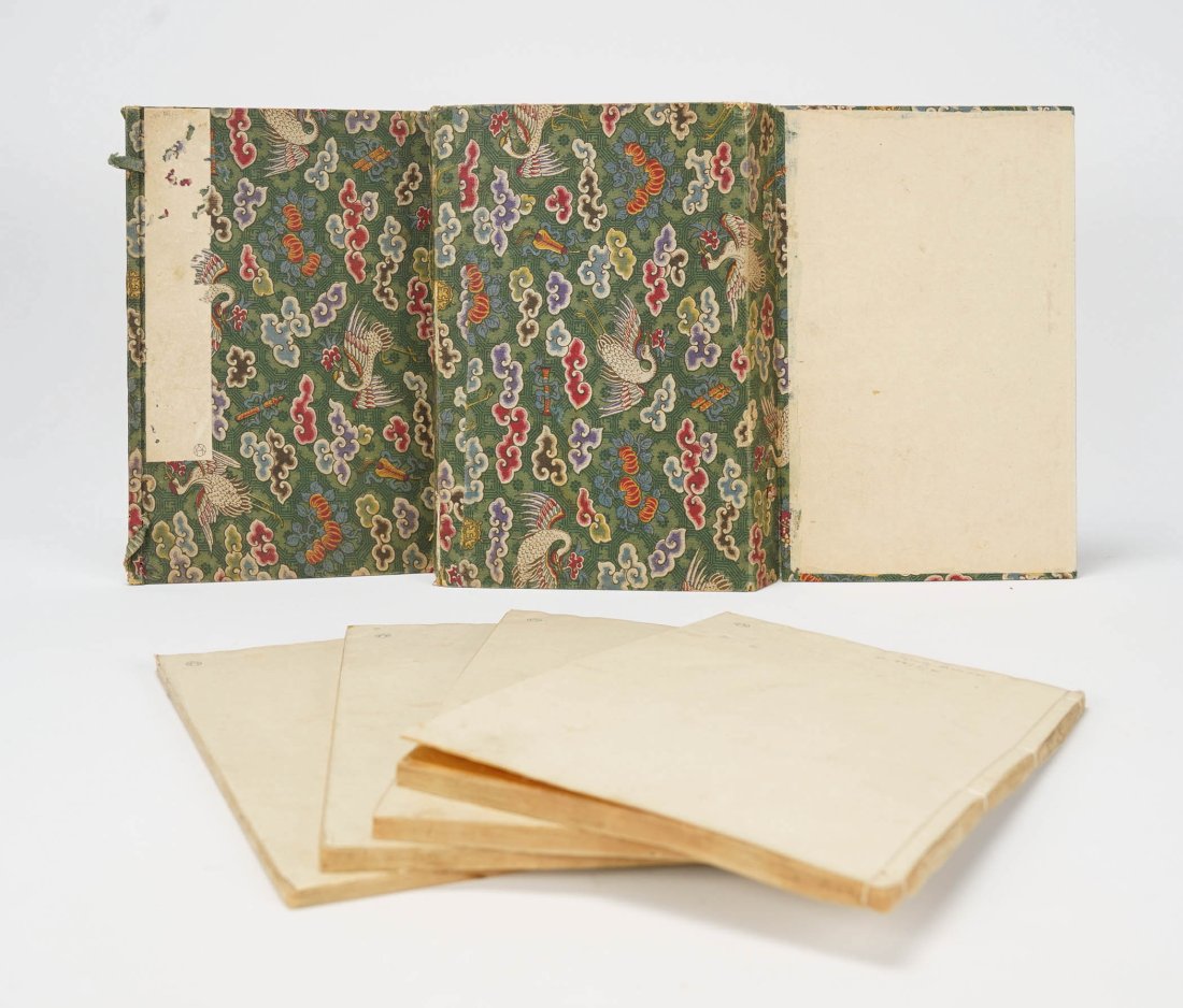 Antique Japanese Woodcut Print Book 4 Volumes Poems: 4 Volume set of woodcuts and poems. Set is enclosed in green fabric with a crane motif. No date. 10" x 6.4" x 1.5". Pages are still supple and flexible. Some pages have pink staining. In the top volum