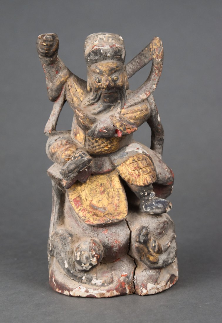 Antique 18thC Chinese Carved Giltwood Painted Warrior Figurine: A Tibetan or possibly Chinese carved wood figural statue of a god or warrior in a sitting position with dragons protruding from the base. Colored with gilt and other paint, much of which has faded. Me