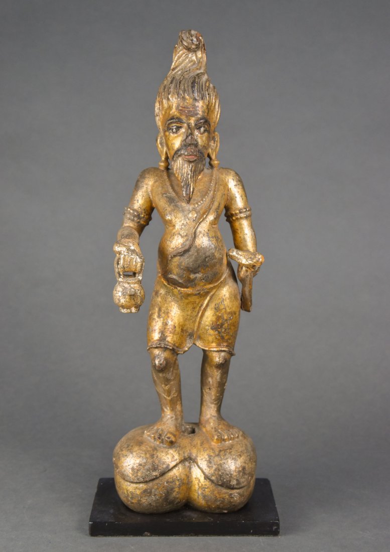 Antique 19thC Carved Giltwood Figurine of a Man with Beard: An Indian giltwood figural statue of a man holding a tea pot in one hand and something else in the other hand. Measurements are approx. 17 3/4" H x 5 1/4" W x 4 1/4" D. All measurements exclude the co