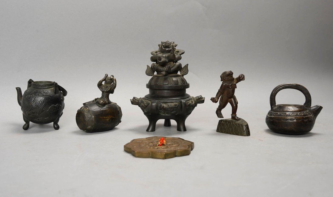 Nice Group of Antique Asian Small Bronze Artifacts incl Teapot Water Dropper: Ca. 19thC. This auction lot includes three Japanese water droppers, one Japanese small mirror form weight, one Burmese bronze miniature figurine (possibly opium weight), and one Chinese bronze miniatu