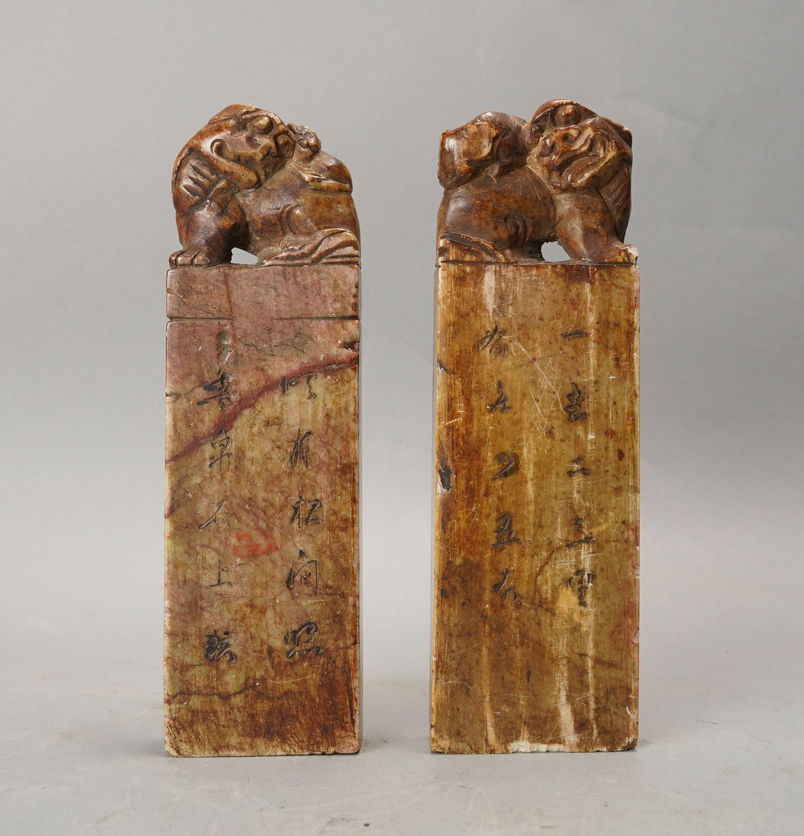 Antique 19thC Mirrored Pair Chinese Carved Soapstone Foo Dog Seals: Ca. mid 19thC. One repaired, both have small chips and dings. Slightly different widths with the non-repaired being an 1/8th of an inch or less larger.