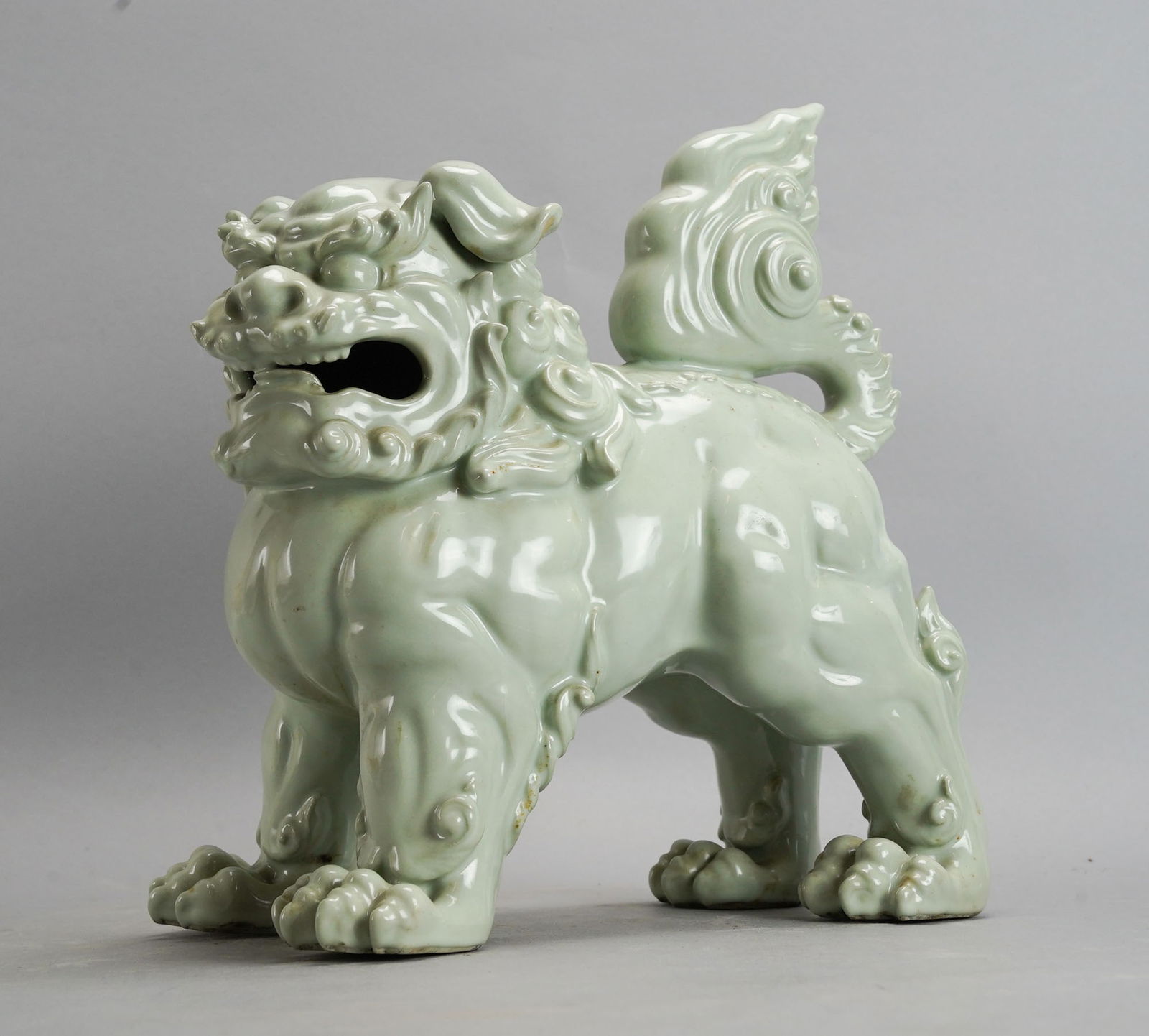 Large Korean 20thC Celadon Porcelain Foo Dog Figurine Statue: Ca. last half 20thC. Very good with no breaks, chips or repairs. Apparently not marked. 11" H x 9 3/4" W x 5 3/4" D