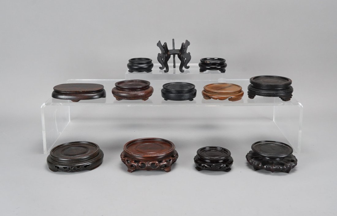 Twelve Good Chinese Carved Hardwood Small Circular Vase Stands: Ca. early to mid/late 20thC. Possibly one or two may be 19thC. Few stands engraved with "MADE IN CHINA". Tall stand measures approx. H: 2 3/4" W: 3", supporting a vase measuring up to 1 1/2". Largest 