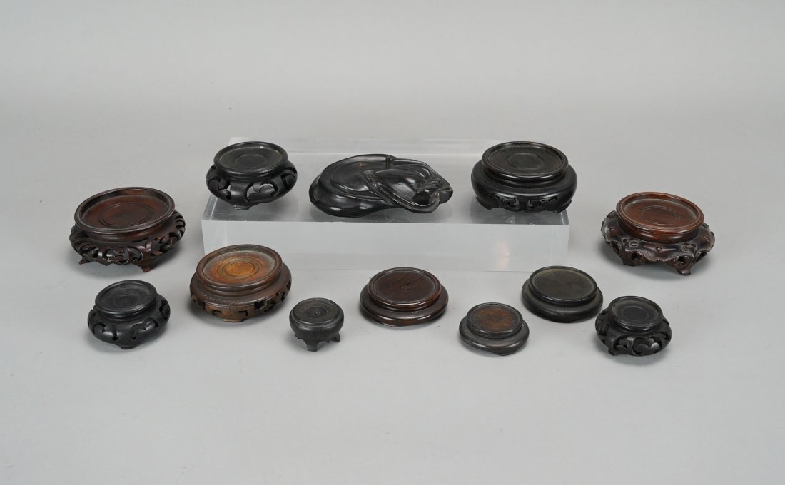 Twelve Good Chinese Carved Hardwood Very Small Circular Vase Stands #2: Ca. early to mid/late 20thC. Possibly one or two may be 19thC. Some stands engraved with "MADE IN JAPAN" and "MADE IN CHINA". Smallest stand measures approx. H: 1/2" W: 1 1/8", supporting a vase of up