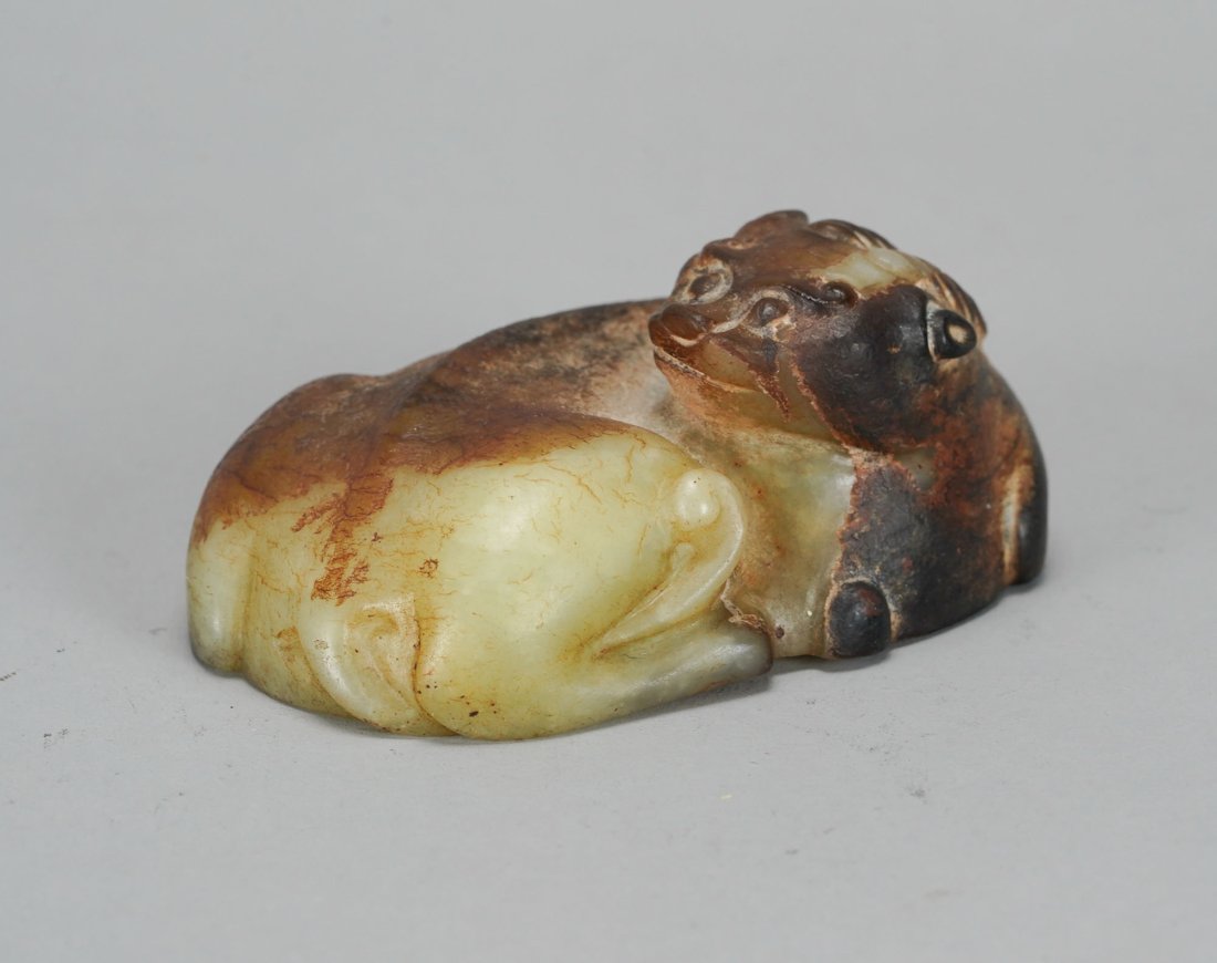 Antique Chinese Carved Multi-Colored Celadon Green & Russet Jade Belt Buckle: Ca. 19thC. Very good with no breaks, cracks, chips or repairs. The top features a mythical beast with twist horns, the underside hides a fox head recessed hook, with a carved plain loop on the opposit