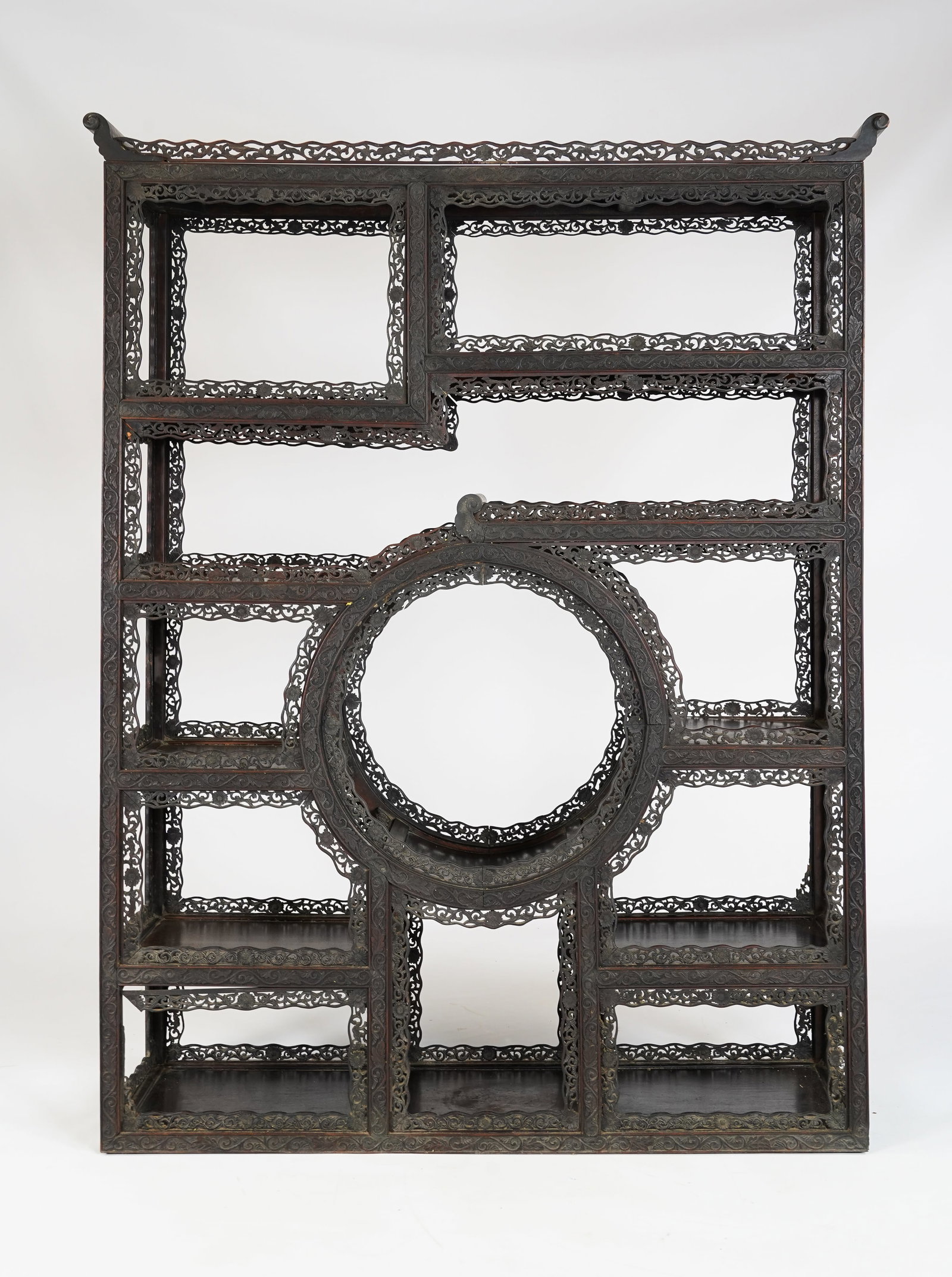 Antique Mid-19thC Ornate Chinese Carved Hardwood Display Wall Shelf: A very good quality hardwood open shelf. Features hand carved pierced fretwork foliate decoration throughout, with a circular design element as the focal point. Good with some missing fretwork pieces,