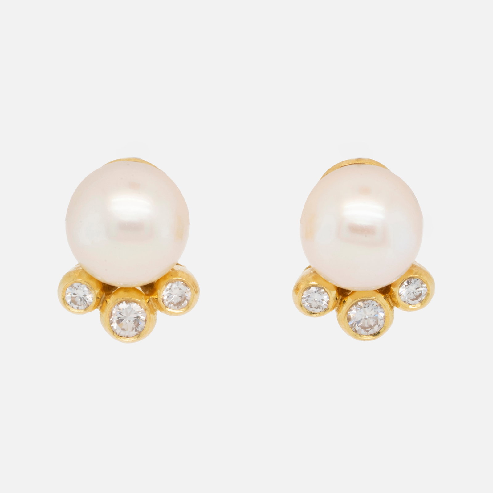 18K Yellow Gold Pearl and Diamond Pair Omega-Back Earrings: Excellent original condition with no breaks or repairs. Each pearl measures approx. 9mm, and each of the six round brilliant-cut diamonds measure 2.5 to 3mm each. Combined weight approx. 7.8 grams.