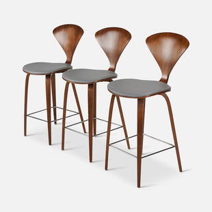 Three Norman Cherner Walnut Counter Bar Stools: Dated 2020. Three walnut bar/counter stools by Norman/Benjamin Cherner of Cherner Chair Company. Very good condition overall, with moderately scratched backs. Approx. seat height 25".