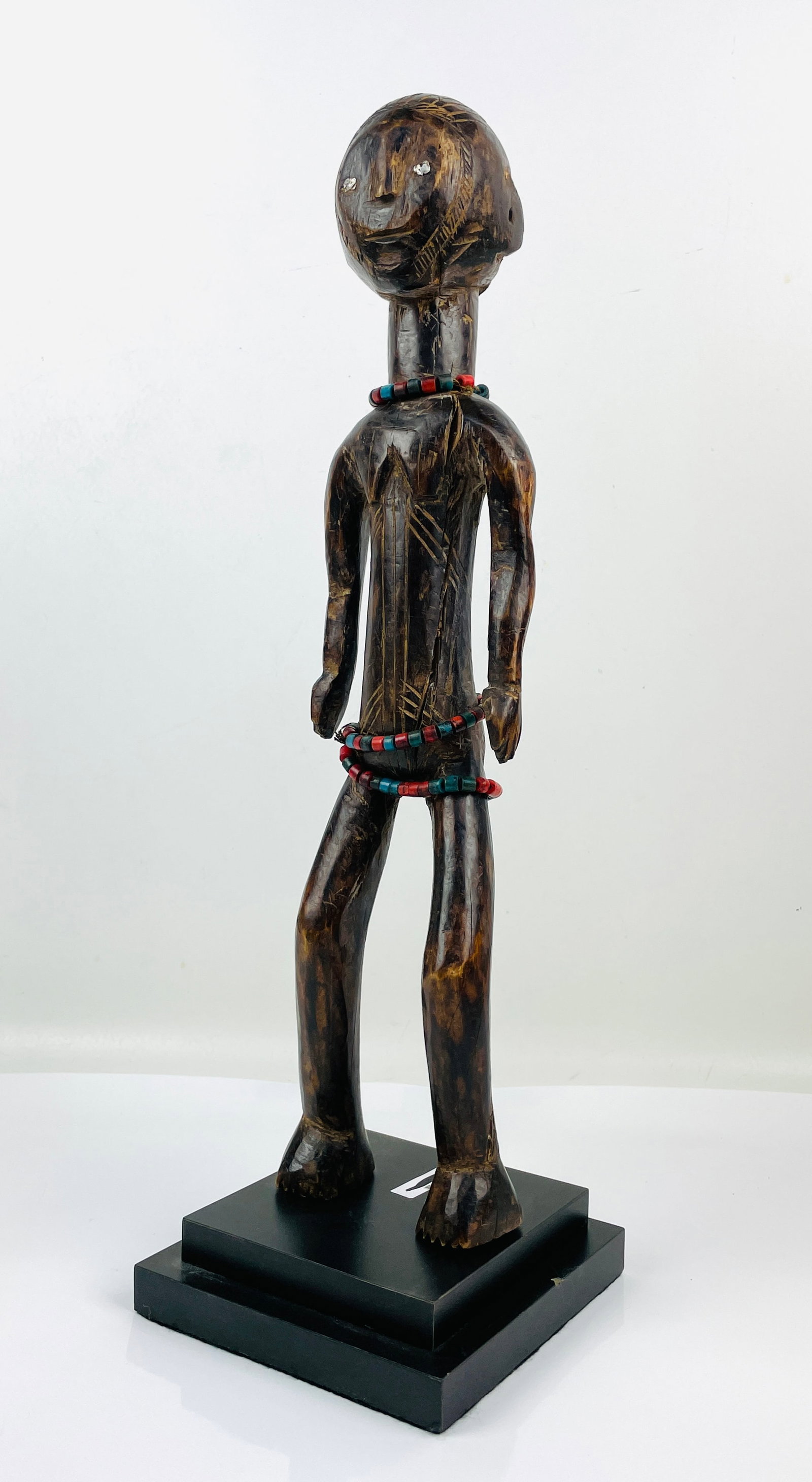 Mbole African Carved Wood Standing Tribal Male Figure Mali w/Trade Beads: Ca. second to third quarter 20thC. Very good with no apparent breaks or repairs. Retains original patina. This item(s) is used, and will show multiple areas of age appropriate wear and surface losses.