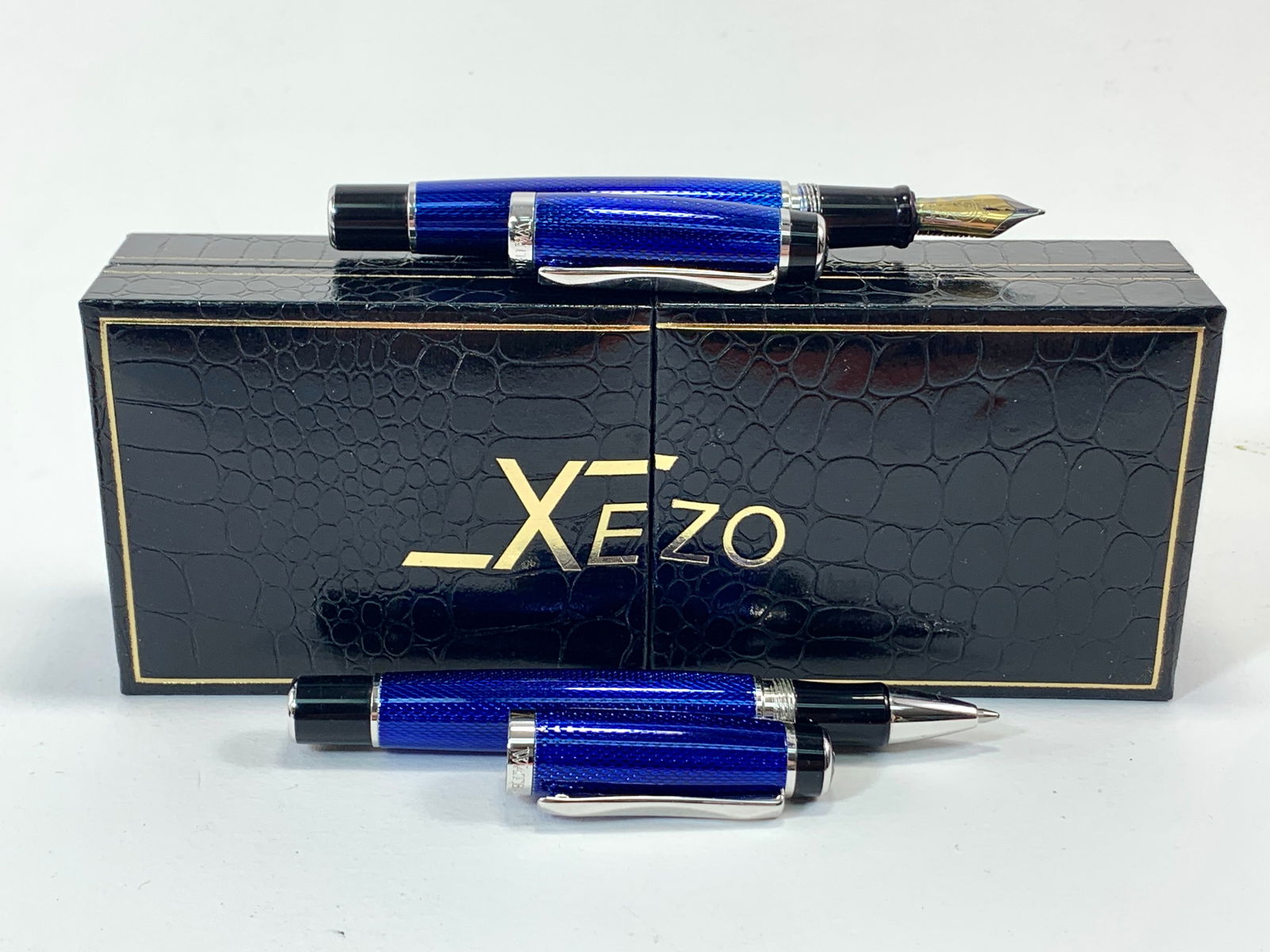 Waterford France Blue Guilloche Enamel and Chrome Fountain and Ballpoint Pen Set w/ Xezo Box: Excellent single use condition, with no defects. Approx. 5 1/4". Glossy finish throughout. Box may show moderate shelf wear, and may include ink stains. Please enlarge pictures to clearly understand b