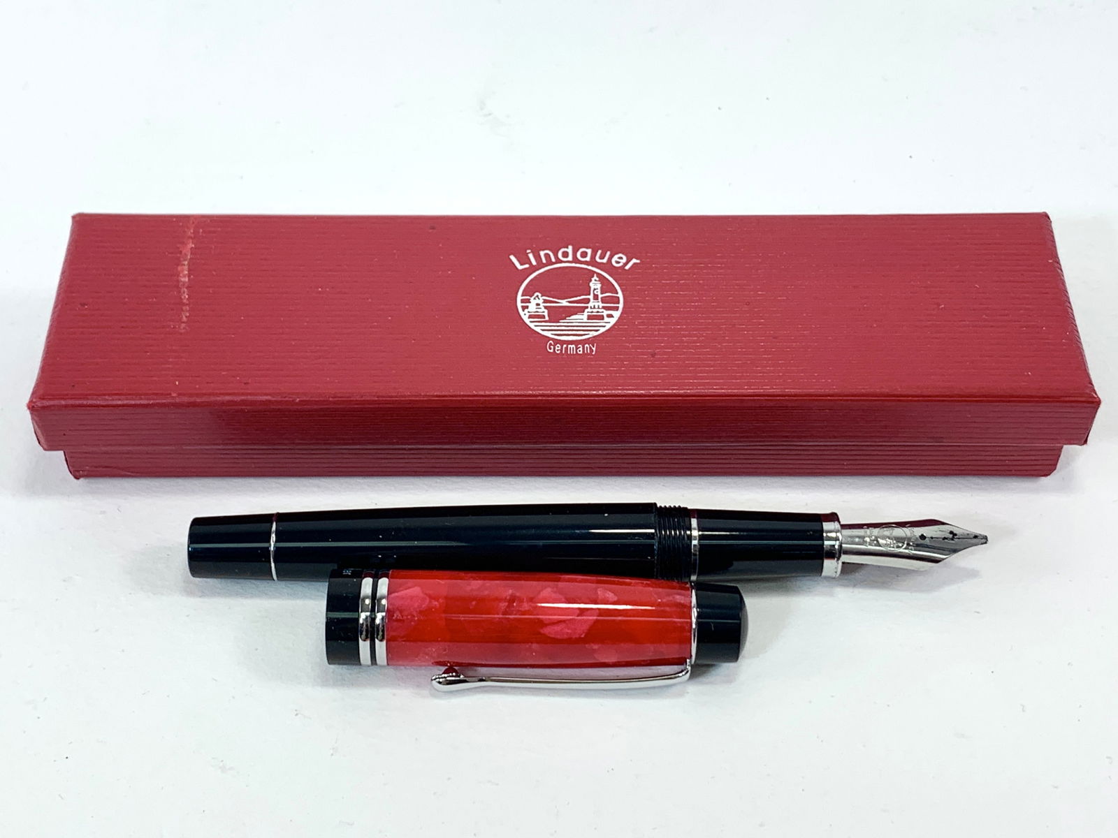 Lindauer German Black, Marbleized Red and Chrome Fountain Pen w/Box: Excellent single use condition, with no defects. Approx. 5 3/8". Glossy finish throughout. Box may show moderate shelf wear, and may include ink stains. Please enlarge pictures to clearly understand b