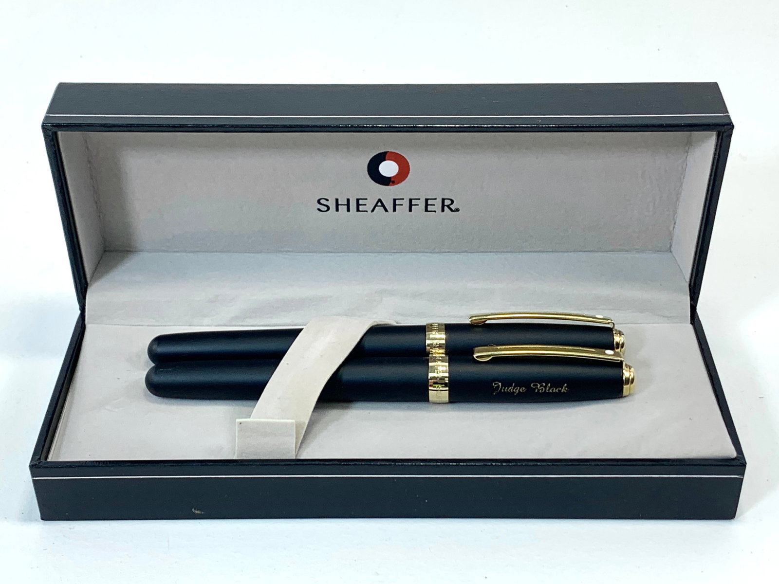 Sheaffer White Dot Matte Black and Gold Fountain Pen and Pencil Set w/Box Inscribed Name: Excellent single use condition, with no defects. Each cap has an inscribed name. Approx. 5 1/4". Matte finish throughout. Box may show moderate shelf wear, and may include ink stains. Please enlarge p